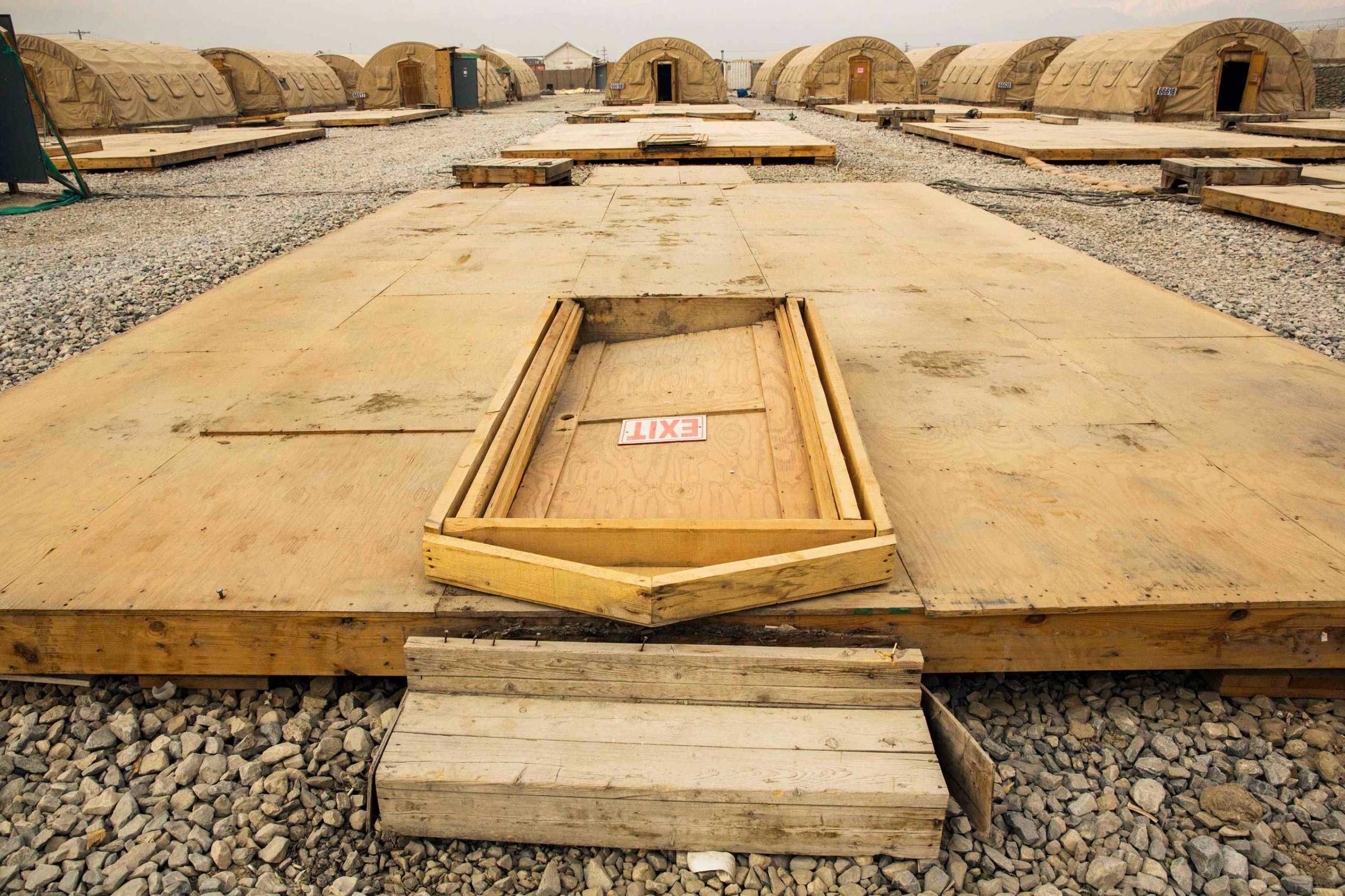 Jan, 2, 2015. A door rests on the floor of a dismantled tent at the Bagram Air Field in the Parwan province of Afghanistan. The base is being shrunk by demolishing large swaths of housing in order to hold roughly 13,000 foreign troops.