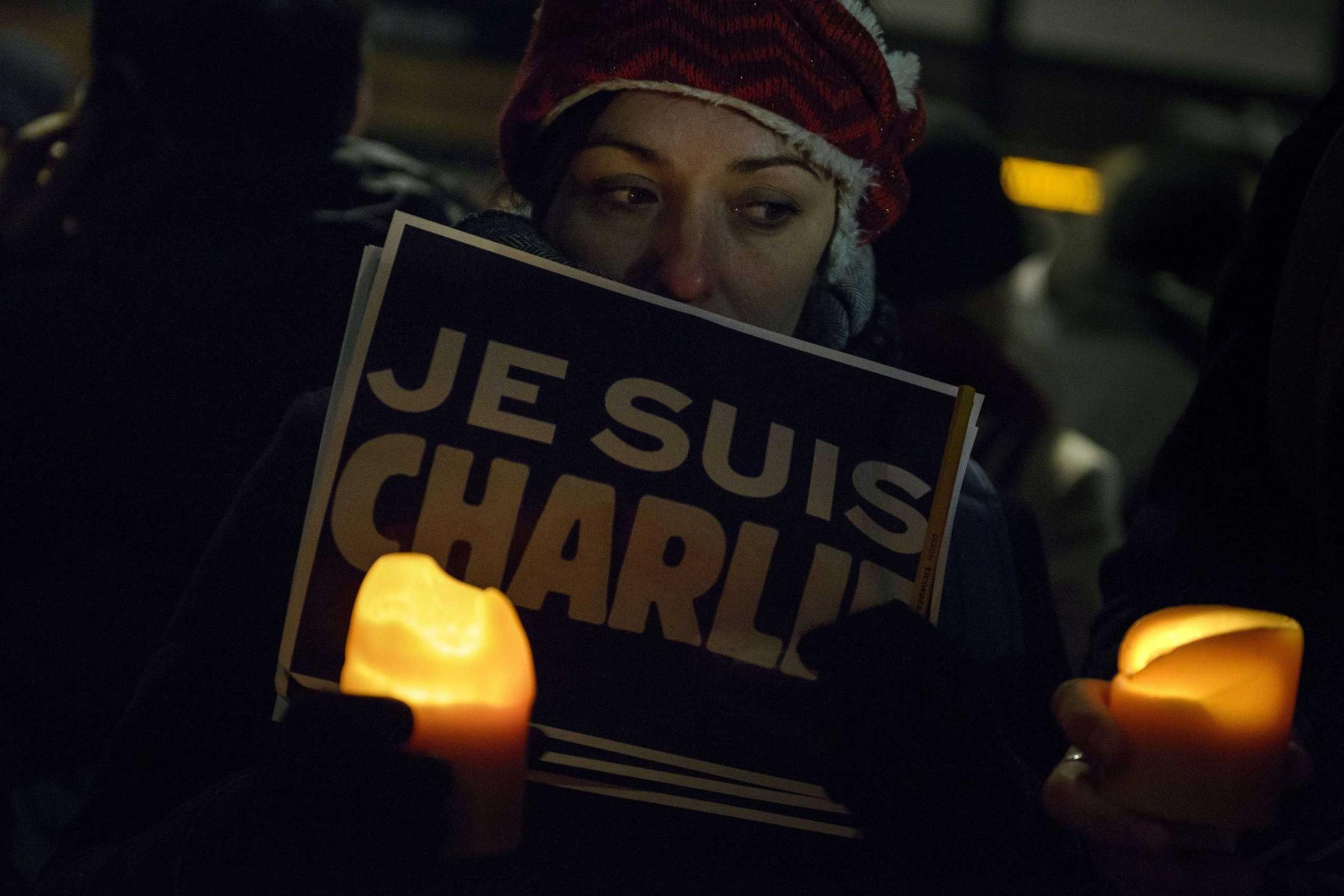 Jan. 7, 2015. People hold posters with the words "Je Suis Charlie" (I Am Charlie) outside the Newseum in Washington, D.C.