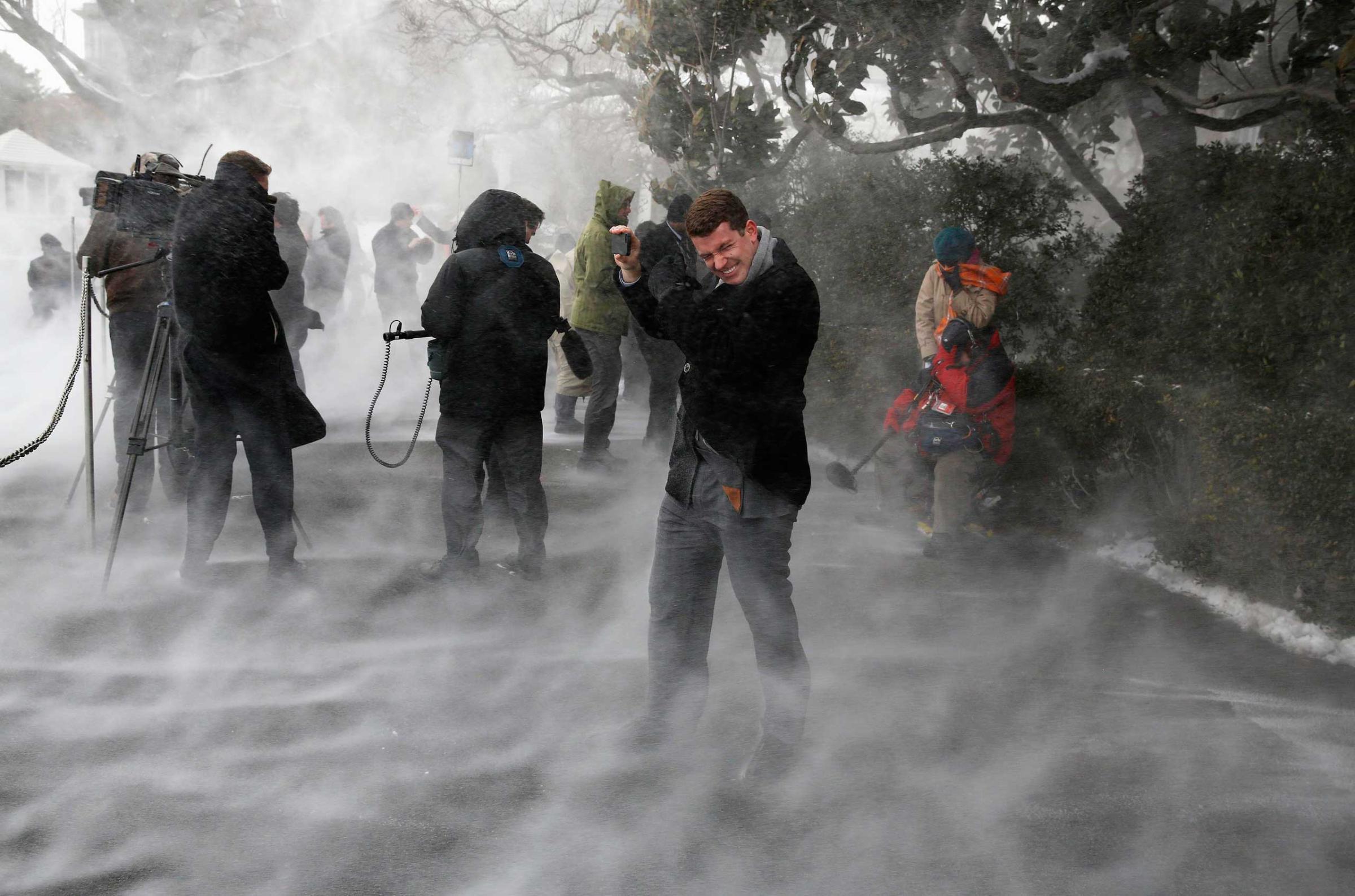 Jan. 7, 2015. Members of the press, including NBC's Evan Dixon, face the blowing snow caused by Marine One as it landed on the South Lawn before picking up U.S. President Barack Obama at the White House in Washington, D.C.