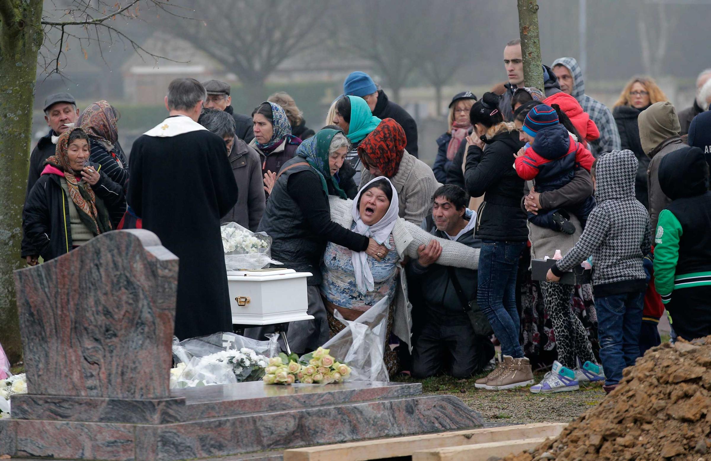 Jan. 5, 2015. The mother of Maria Francesca, who died of sudden infant death syndrome, cries in front of the coffin of her baby during the funeral in Wissous, outside Paris.