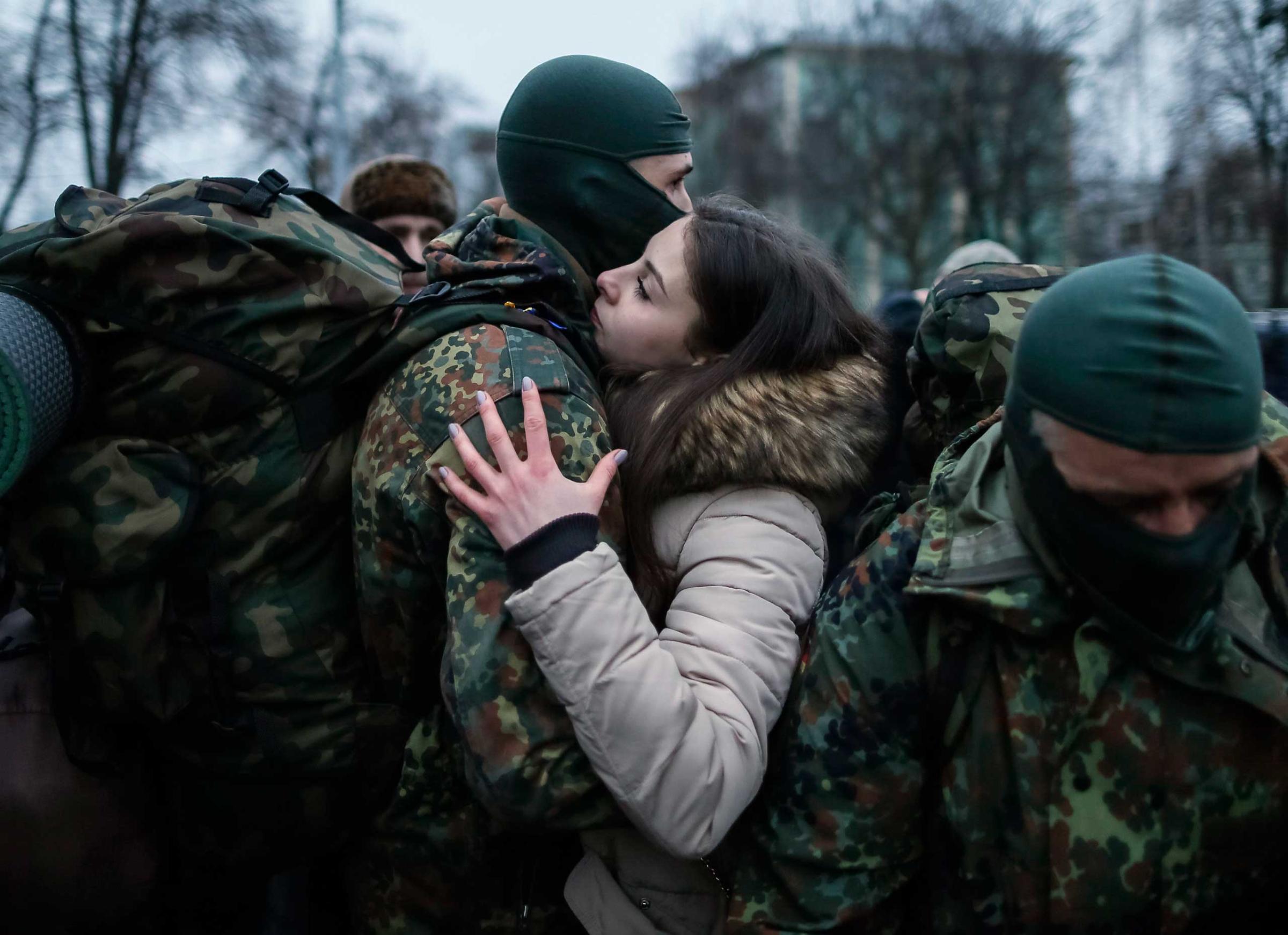 A new volunteer for the Ukrainian Interior Ministry's Azov battalion embraces his girlfriend before departing to the frontlines in eastern Ukraine, in central Kiev