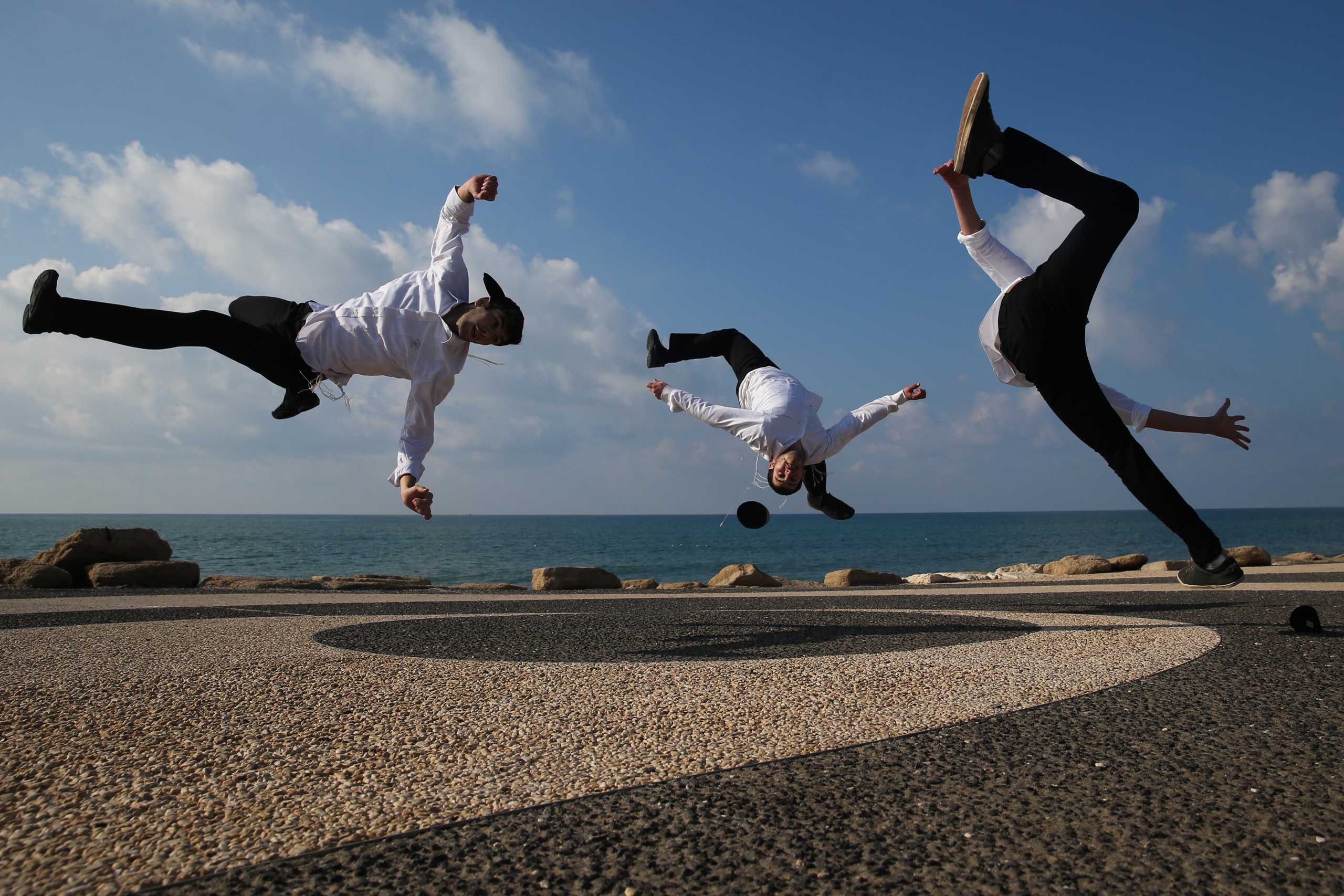 Jan. 18, 2015. Ultra Orthodox Jewish Micky Hayat practices Capoeira, a Brazilian martial art that combines elements of dance, acrobatics and music, with his students near the port of Tel Aviv.