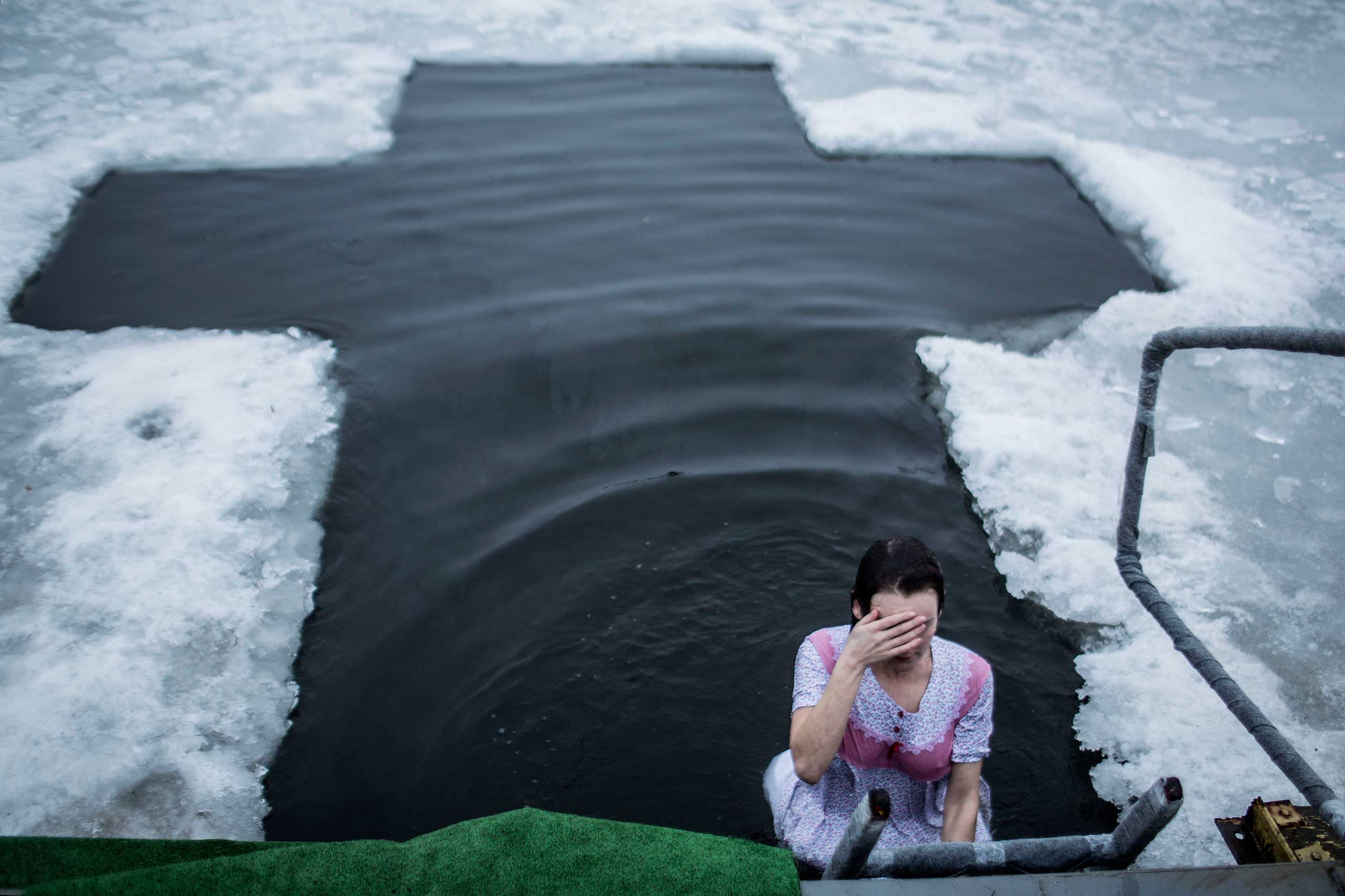 Jan. 19, 2015. A Ukrainian woman takes a bath in the lake of Sherbakova Park during the celebration of the Orthodox Epiphany in Donetsk, Ukraine. The holiday marks the day God manifested himself in the human form of Jesus.