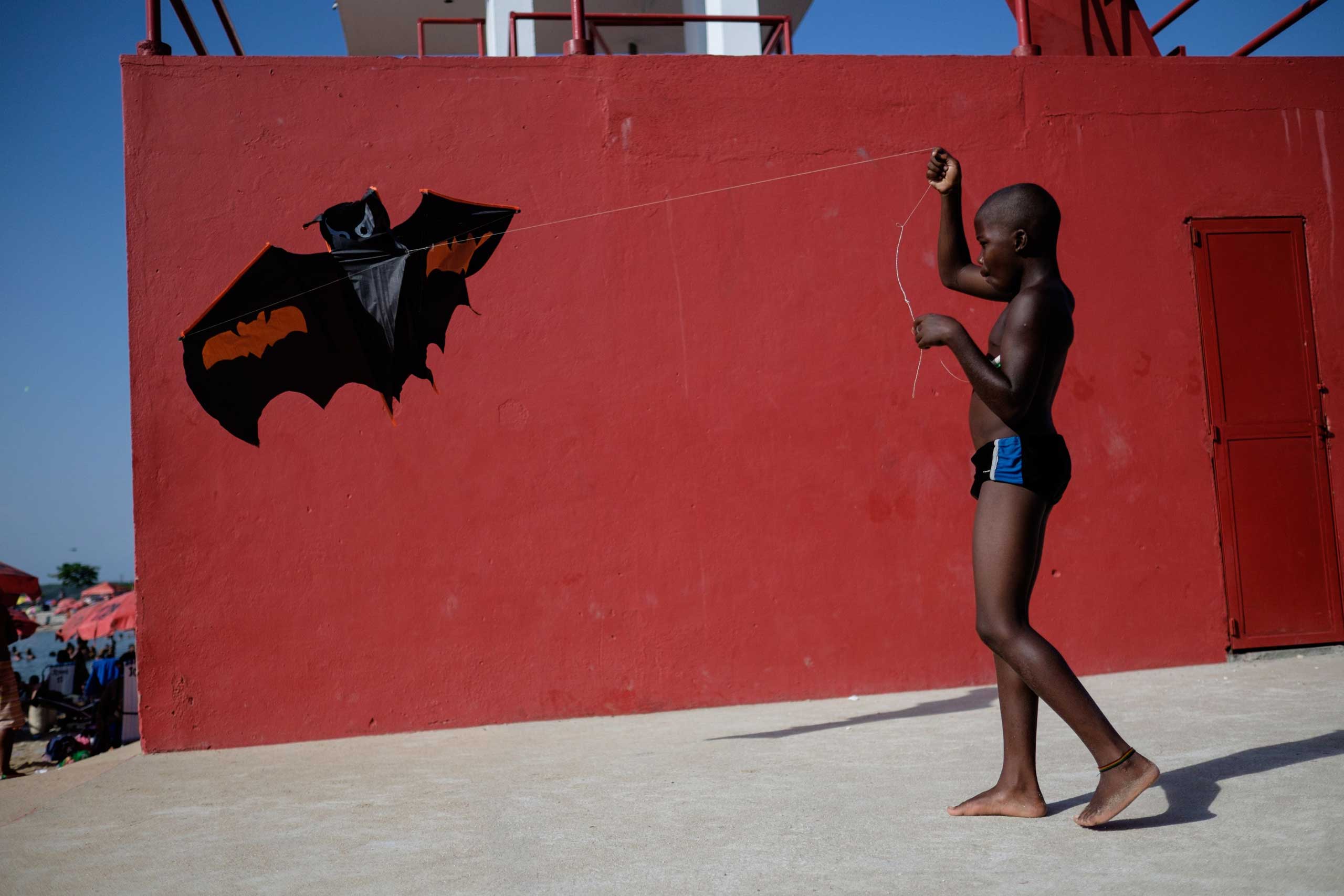 Jan. 19, 2015. A boy plays with a kite at the Ramos Pool as temperatures reached 113 Fahrenheit in Rio de Janeiro. The Ramos Pool, inaugurated in 2001, is an artificial beach associated to a public salt pool which filters the polluted seawater from the Guanabara bay located next to it.