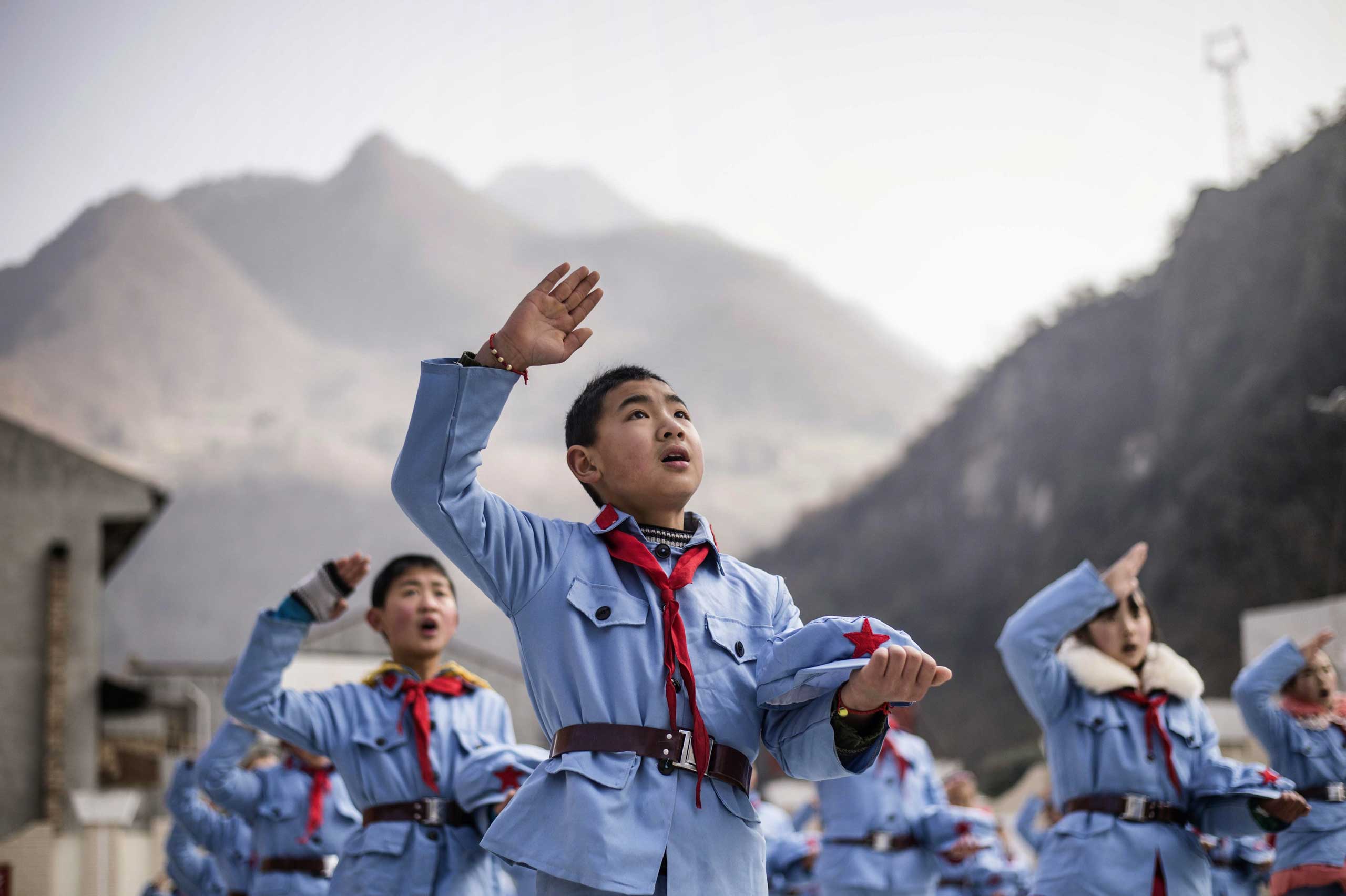 Jan. 21, 2015. Children dressed in uniform sing after raising the national flag at the Beichuan Red army elementary school in Beichuan, southwest China's Sichuan province.