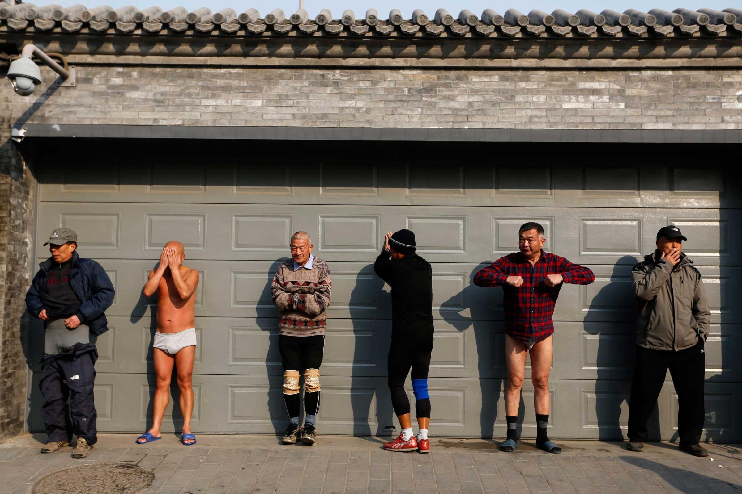 Jan. 12, 2015. Chinese winter swimming enthusiasts warm up before swimming in the half-frozen Houhai lake with a water temperature around 36 fahrenheit in Beijing.