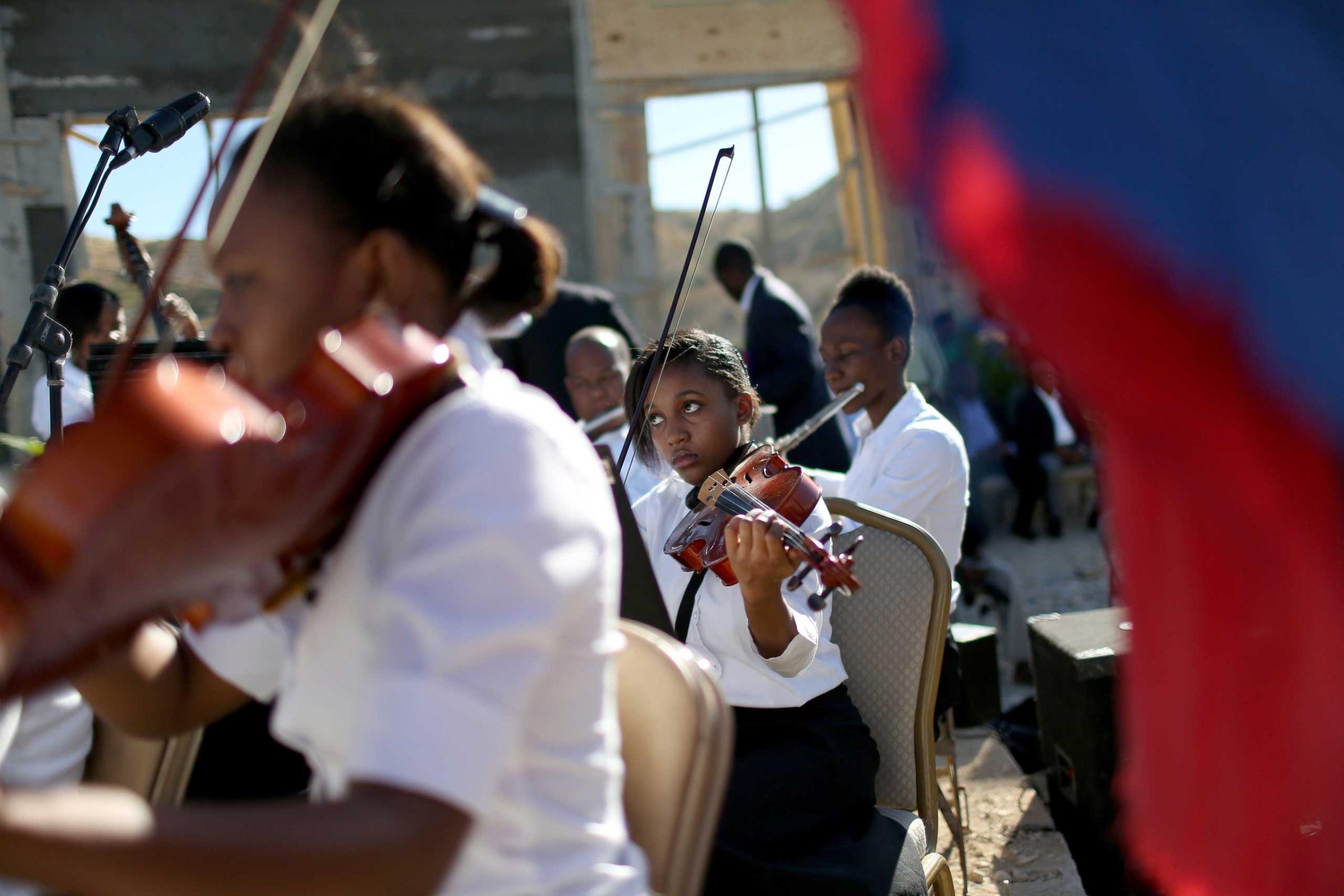 Jan. 12, 2015. Musicians play during a ceremony to remember those killed and buried in the mass grave in Titanyen, Haiti, during a service for the 5-year anniversary of a magnitude 7.0 earthquake that killed 316,000 people.
