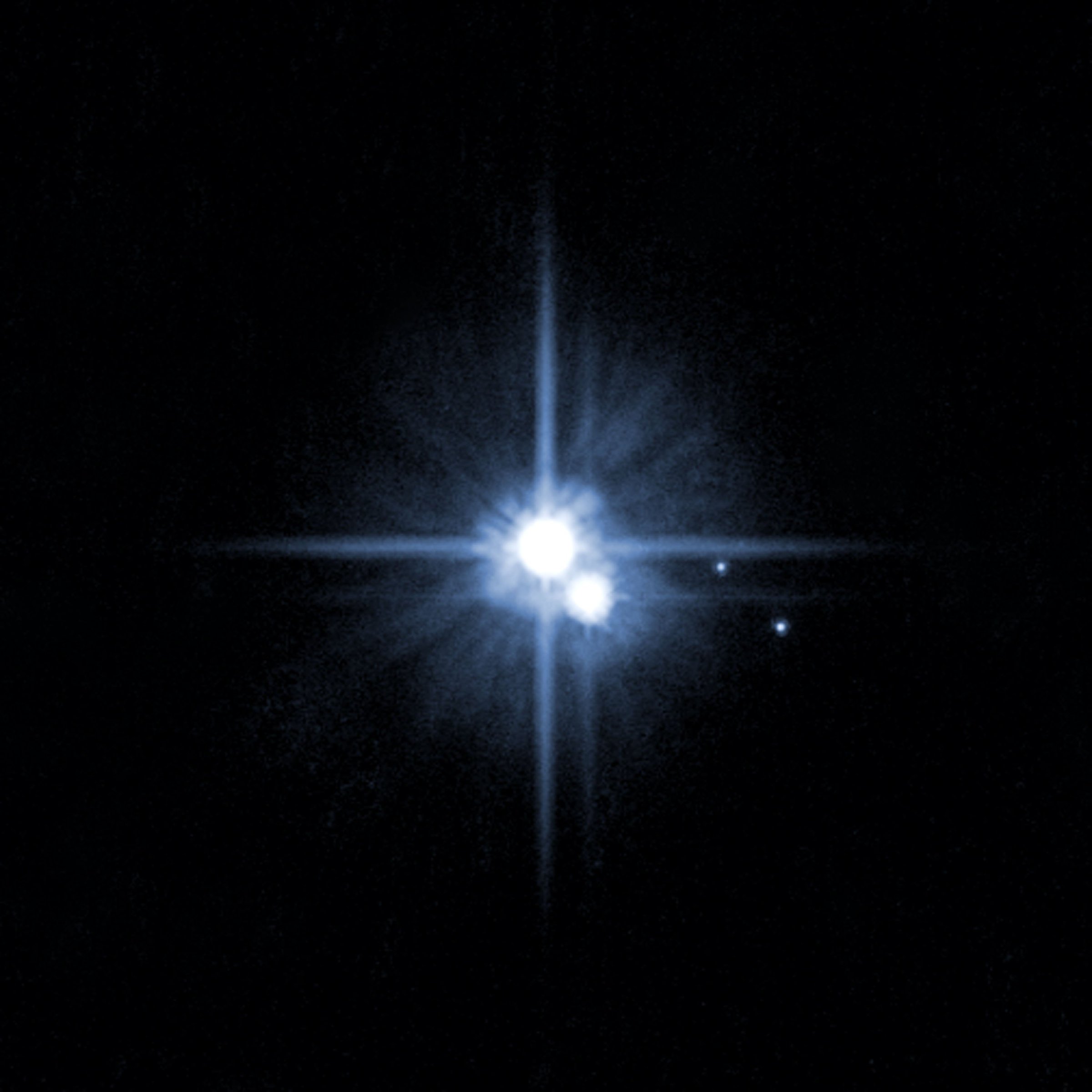 I want to go to there: Pluto and three of its moons, photographed by the Hubble Space Telescope