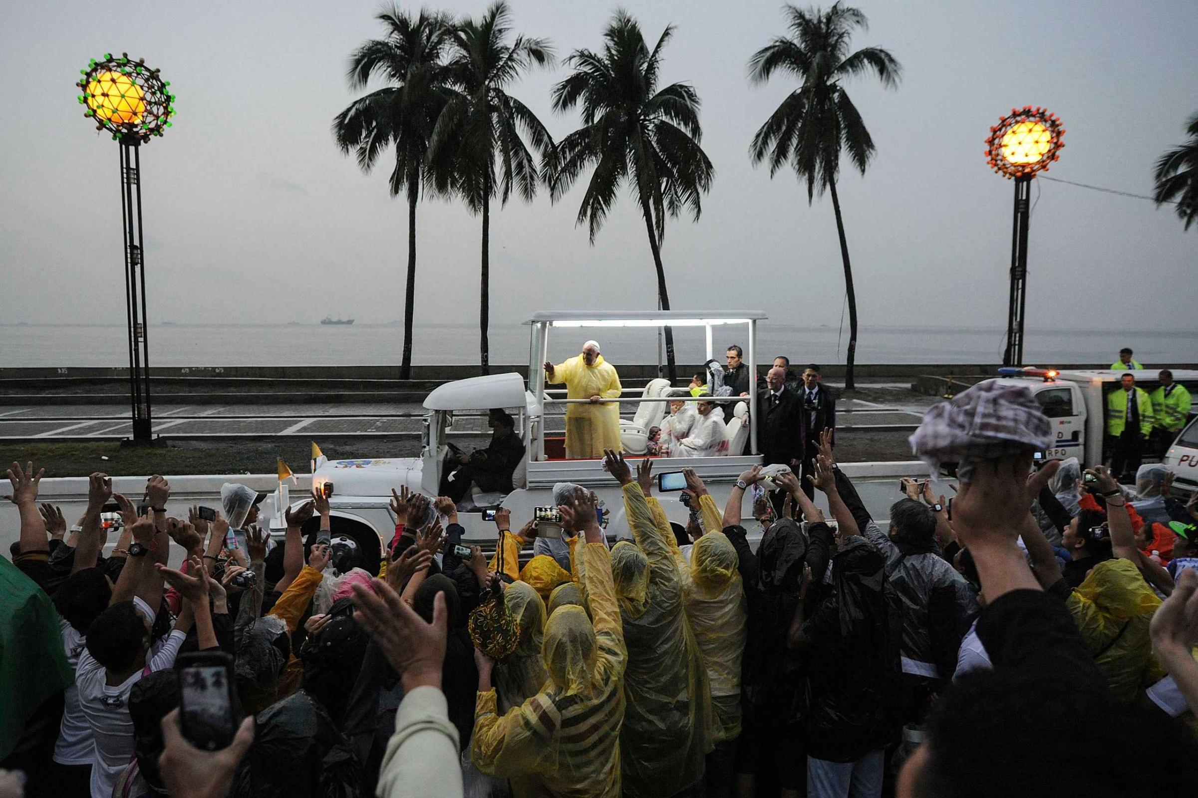 Pope Francis waves from the popemobile after leading a Mass at Rizal Park in Manila, Jan. 18, 2015.