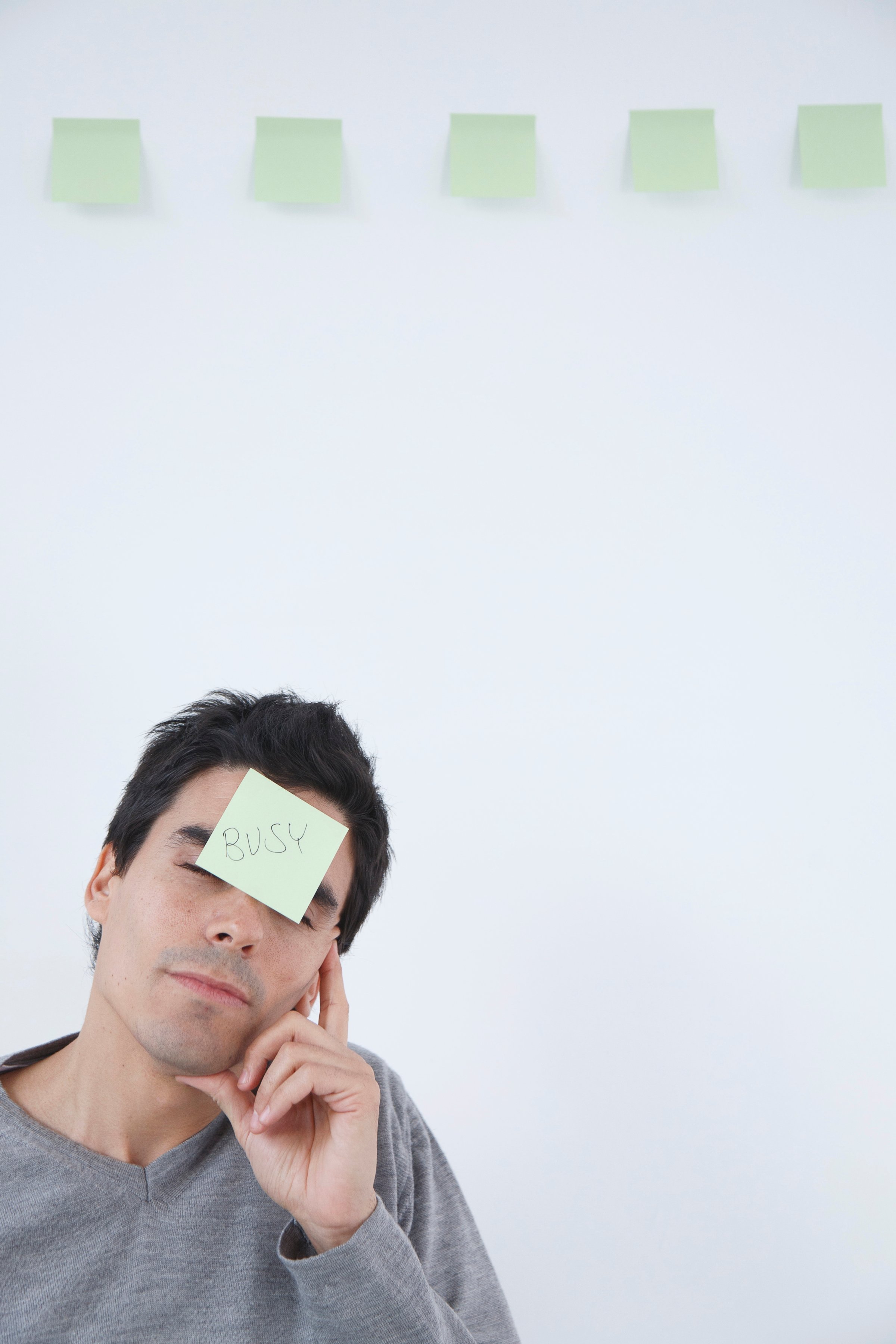 Man with 'busy' post-it note on his head