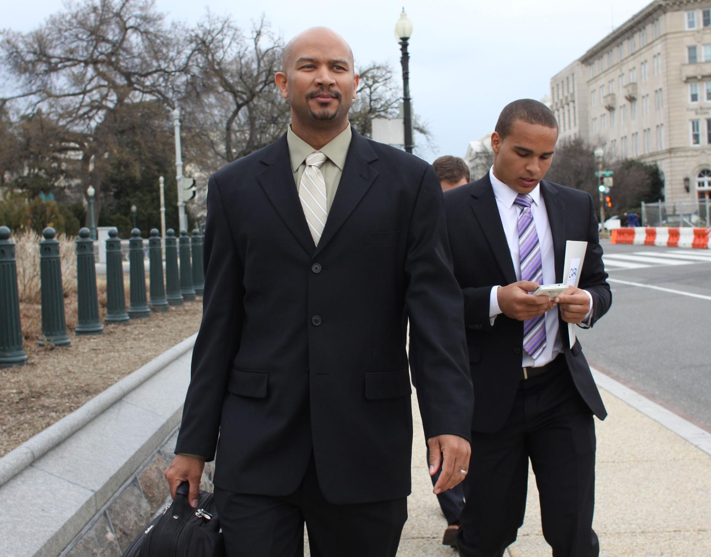 Ramogi Huma (left), founder and president of the National College Players Association, arrive on Capitol Hill in Washington on April 2, 2014.