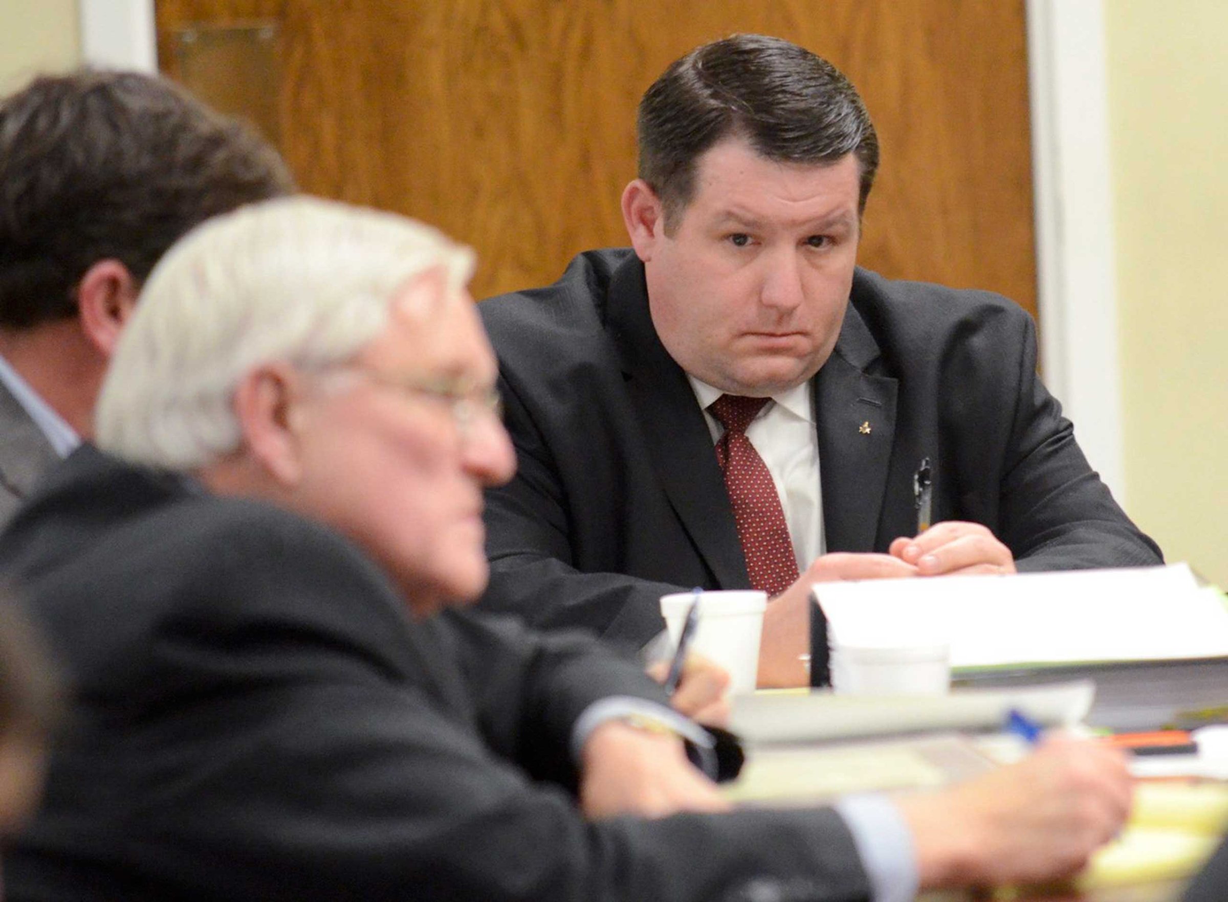 Former Eutawville Police Chief Richard Combs sits with lawyers on the second day of testimony in his trial for the murder of Bernard Bailey in Orangeburg, South Carolina, Jan. 8, 2015.