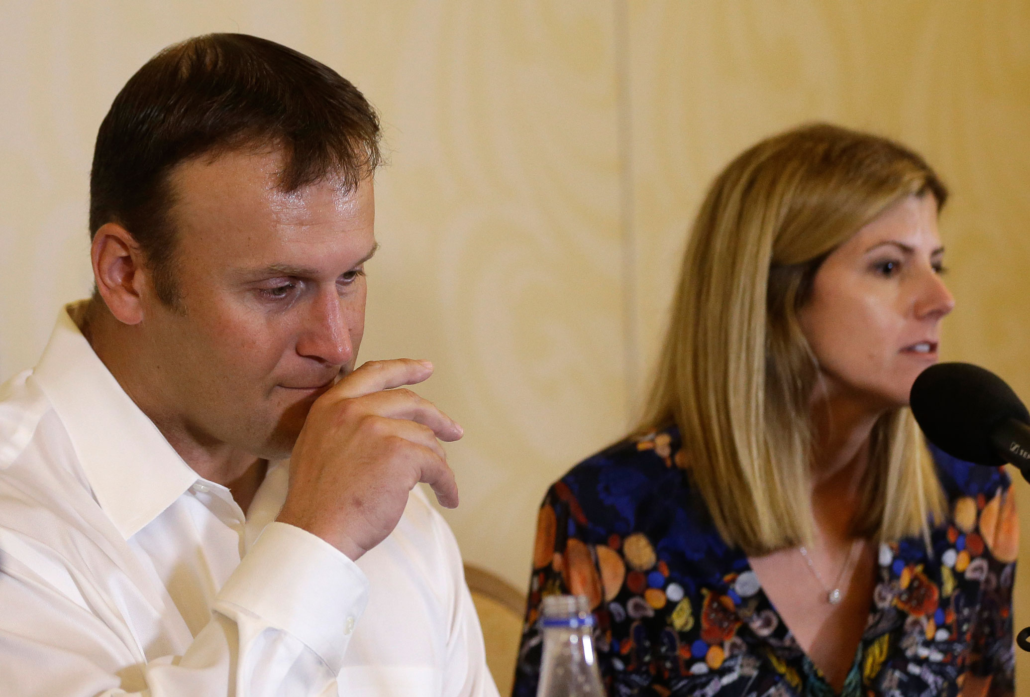 Former Miami Dolphins fullback Rob Konrad, left, listens while his wife Tammy, right, responds to a question during a news conference on Jan. 12, 2015, in Plantation, Fla. (Lynne Sladky—AP)