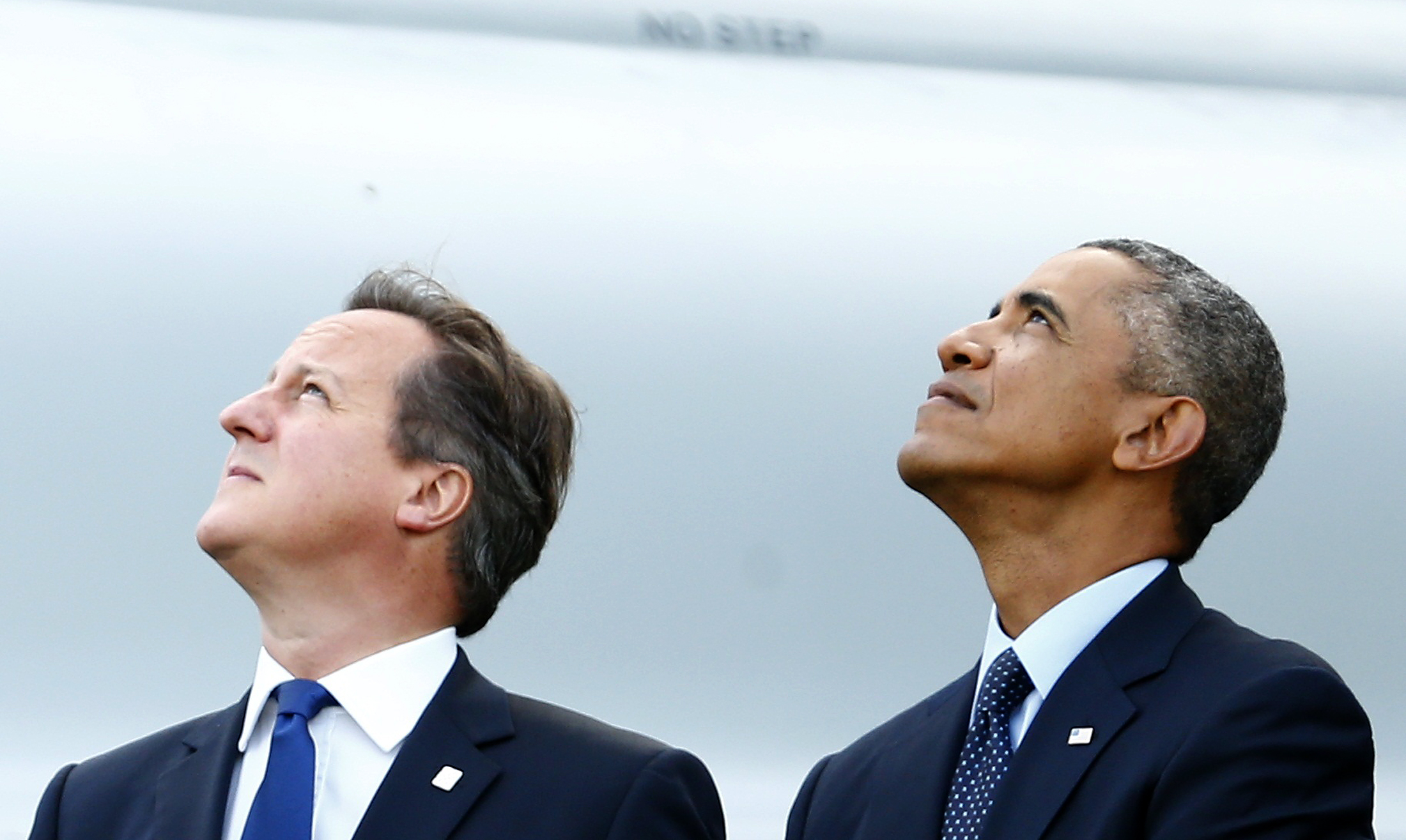 Britain's Prime Minister David Cameron and U.S. President Barack Obama watch a fly-past by the Red Arrows during the NATO summit at the Celtic Manor resort, near Newport