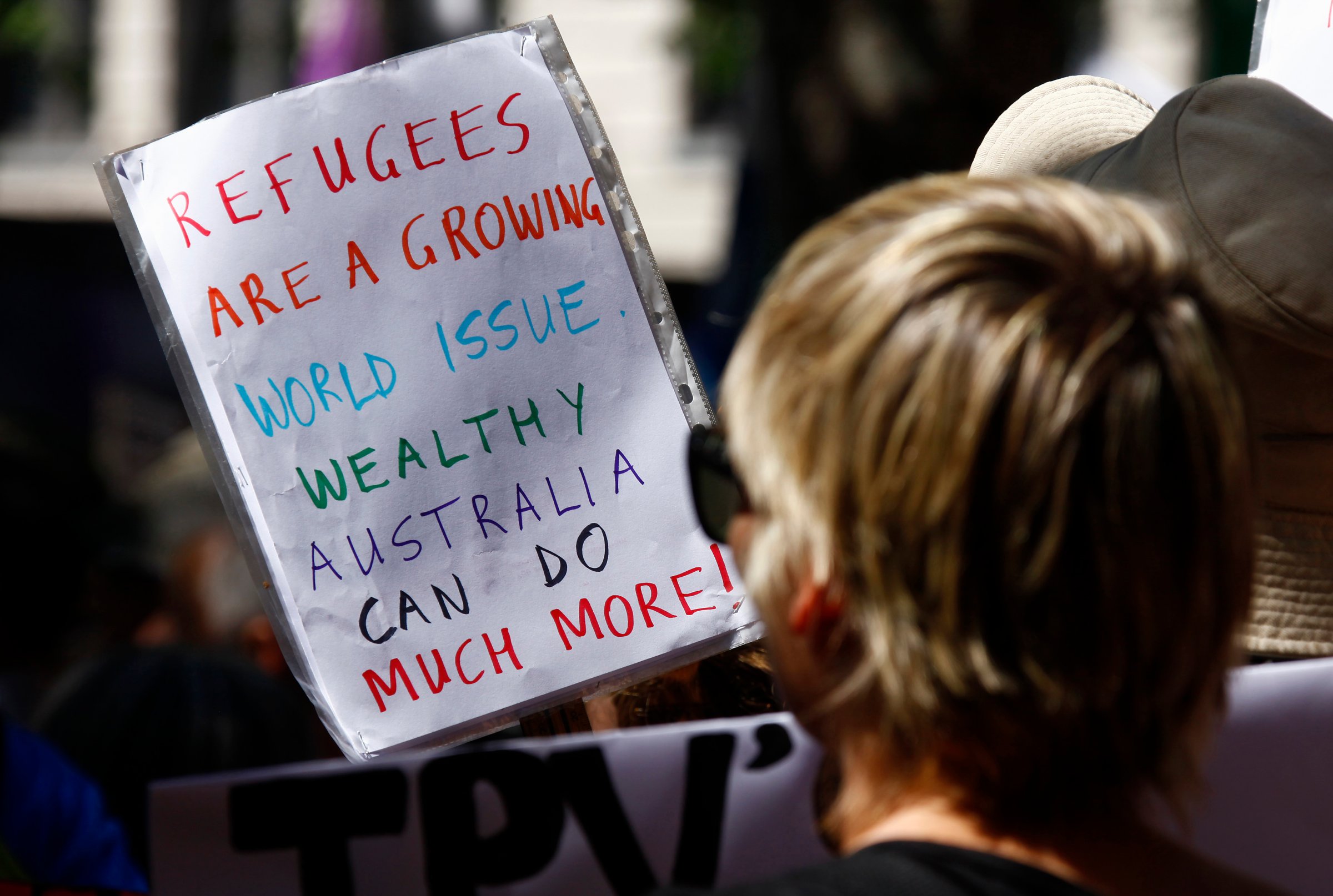 Protesters hold placards at the 'Stand up for Refugees' rally held in central Sydney