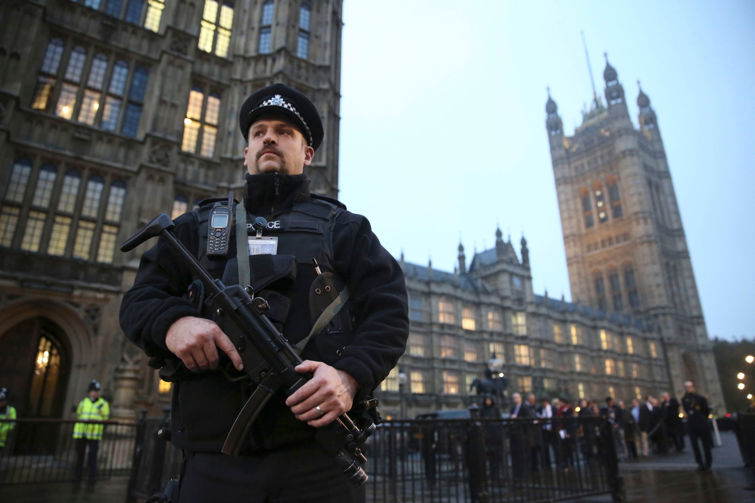 An armed police officer stands outside the Houses of Parliament, central London