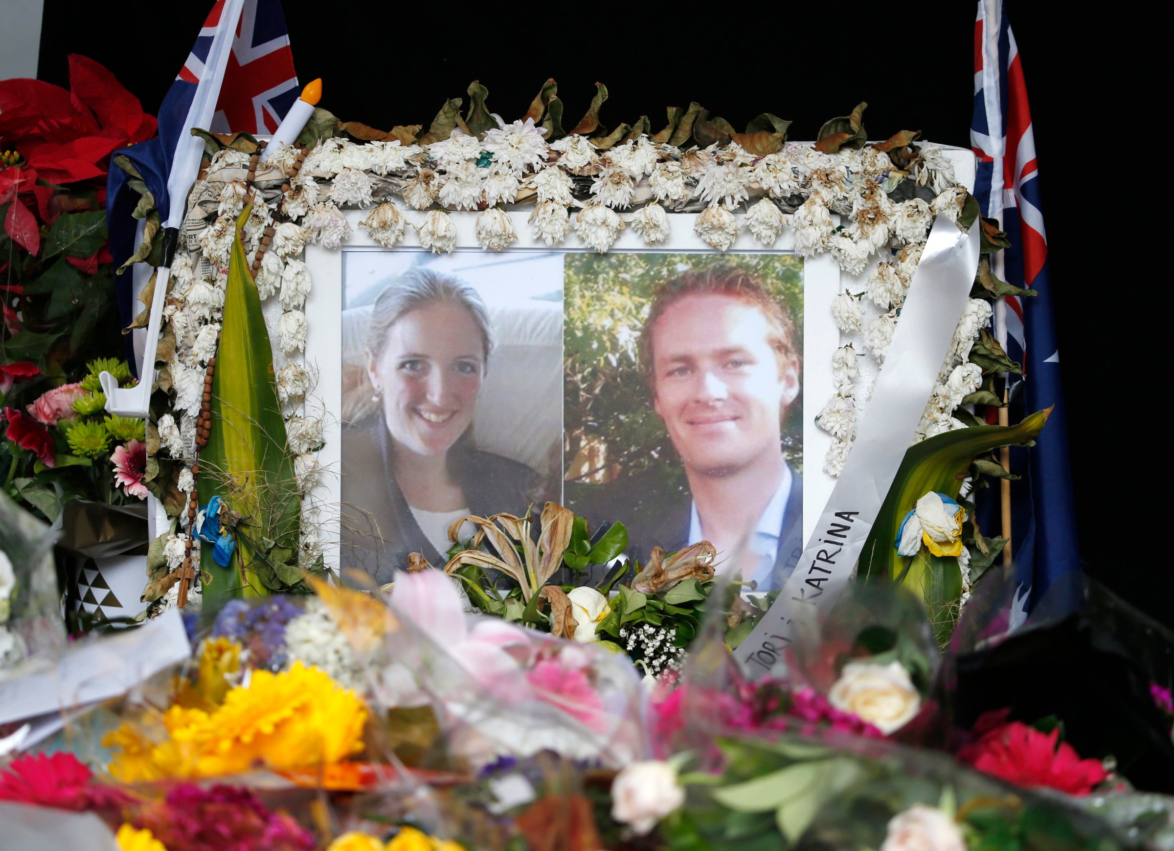Photographs of Sydney's cafe siege victims, lawyer Katrina Dawson and cafe manager Tori Johnson are displayed in a floral tribute near the site of the siege in Sydney's Martin Place