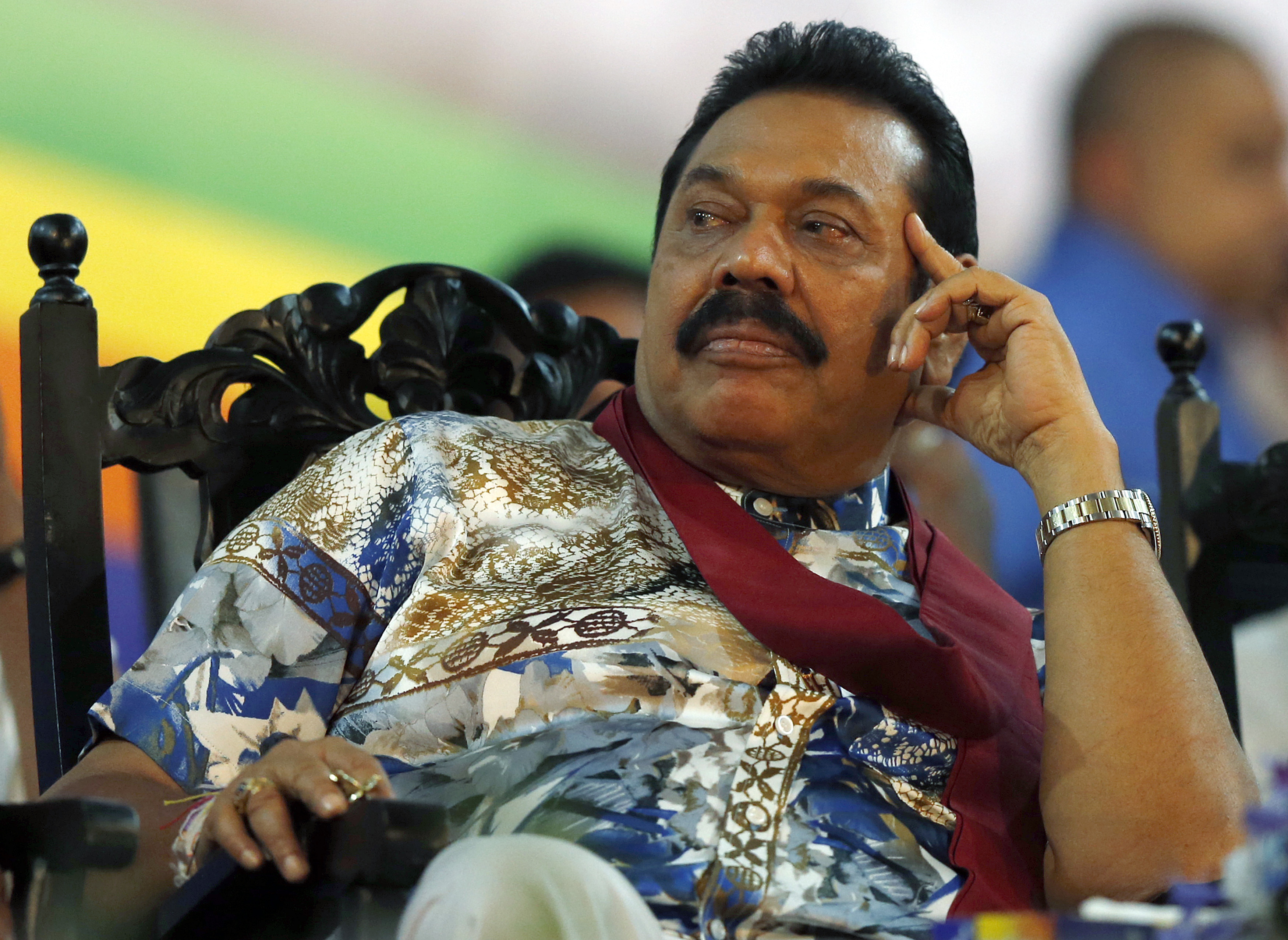 Sri Lankan President Mahinda Rajapaksa listens to a speech during his final rally ahead of presidential election in Piliyandala