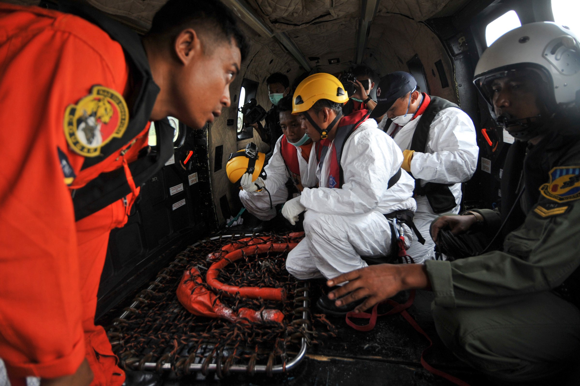Search and rescue teams and flight crew prepare their gear on board an Indonesian Air Force Super Puma helicopter before a search mission for debris and bodies from AirAsia flight QZ8501at Iskandar Air Force Base, in Pangkalan Bun