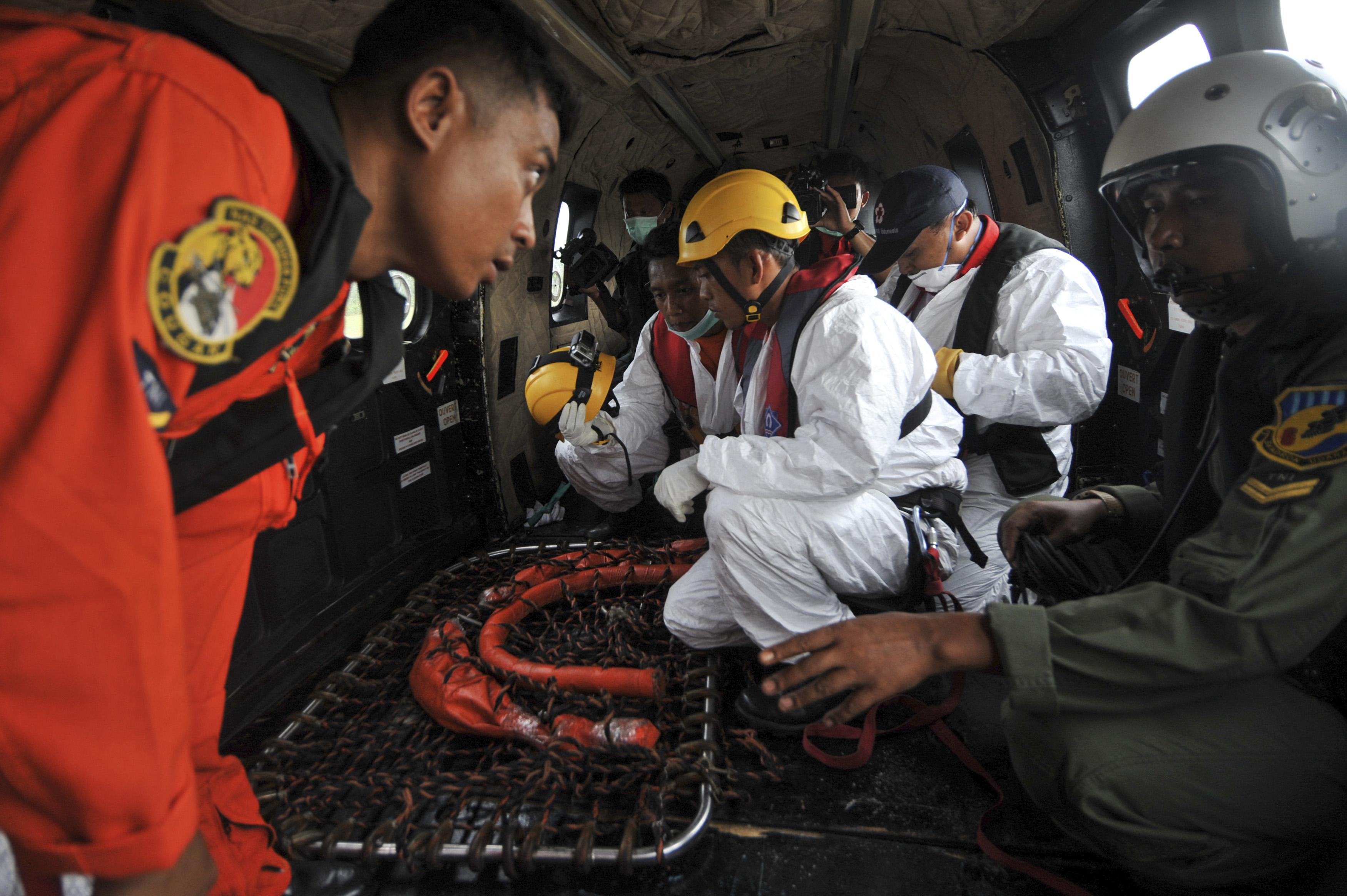 Search-and-rescue workers and flight crew prepare their gear on board an Indonesian air force's Super Puma helicopter at Iskandar air-force base in Pangkalan Bun, Indonesia, before a search mission for debris and bodies from AirAsia Flight QZ 8501 on  Jan. 6, 2015 (Veri Sanovri—Reuters)