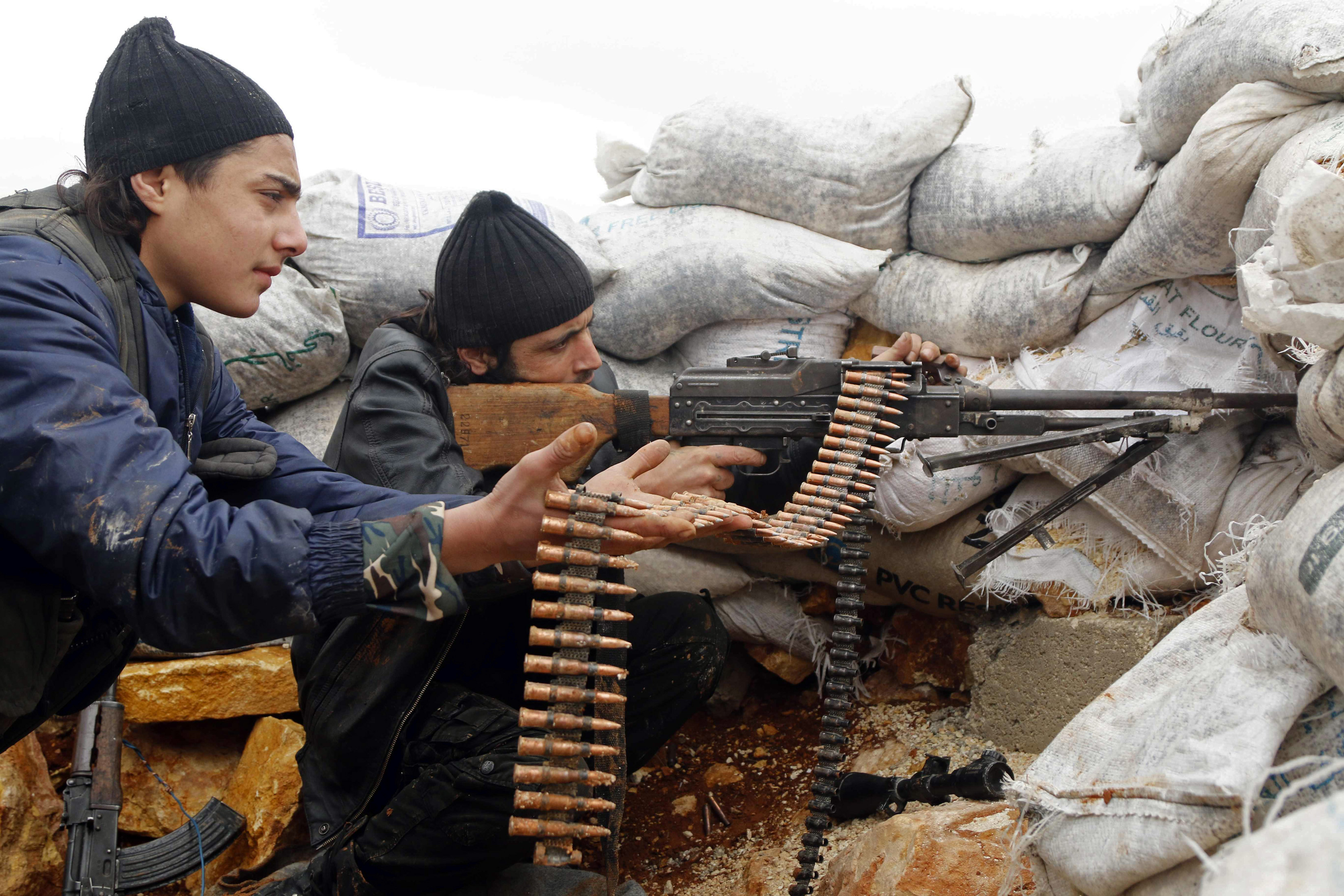 Rebel fighters fire a weapon on the al-Breij frontline, after what they said was an advance by them in the Manasher al-Hajr area where the forces of Syrian President Bashar Assad were stationed in Aleppo, Syria, on Jan. 7, 2015 (Hosam Katan—Reuters)