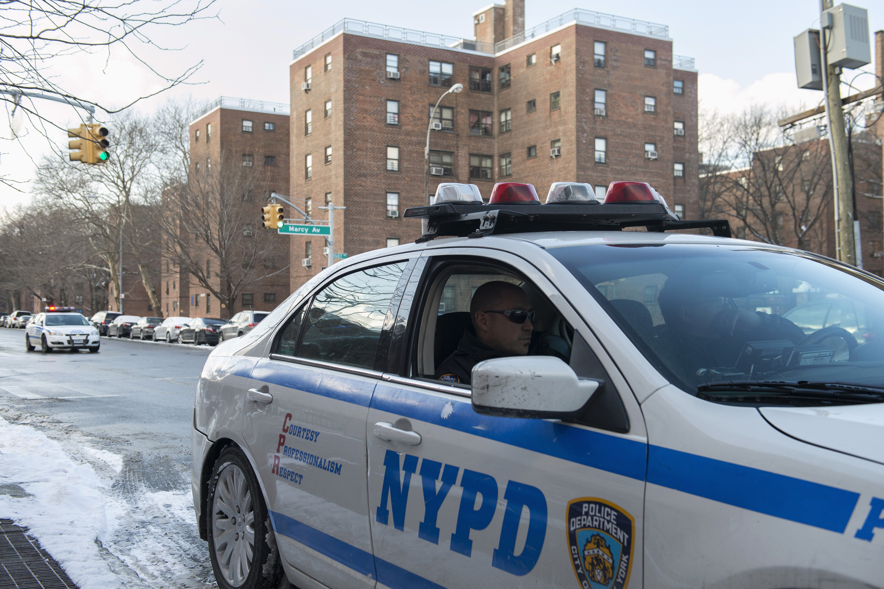 A NYPD patrol vehicle is seen near the Marcy Houses public housing development in the Brooklyn borough of New York