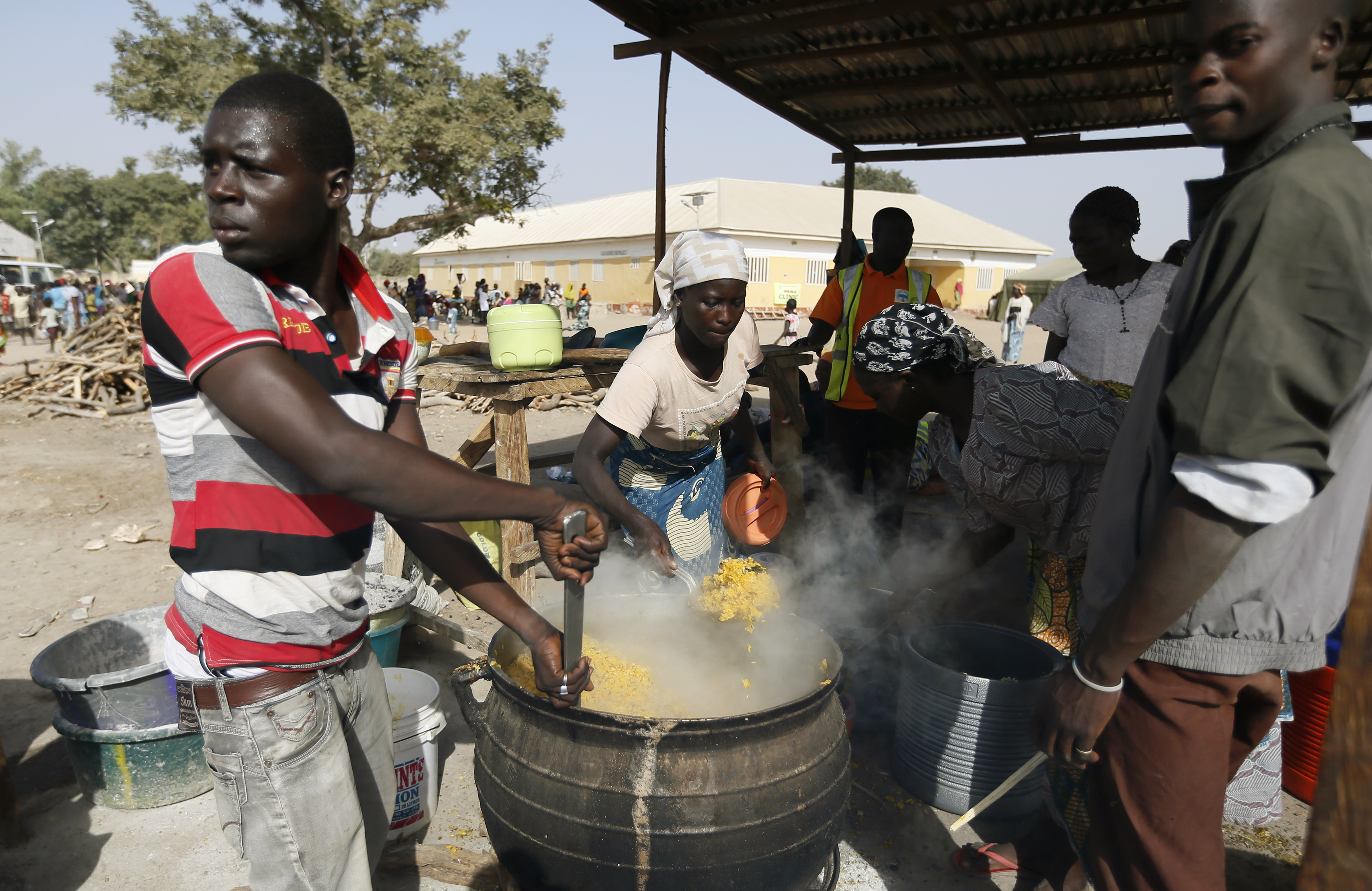 People fleeing Boko Haram violence in the northeast region of Nigeria, cook food at Maikohi secondary school IDP camp in Yola, Adamawa State