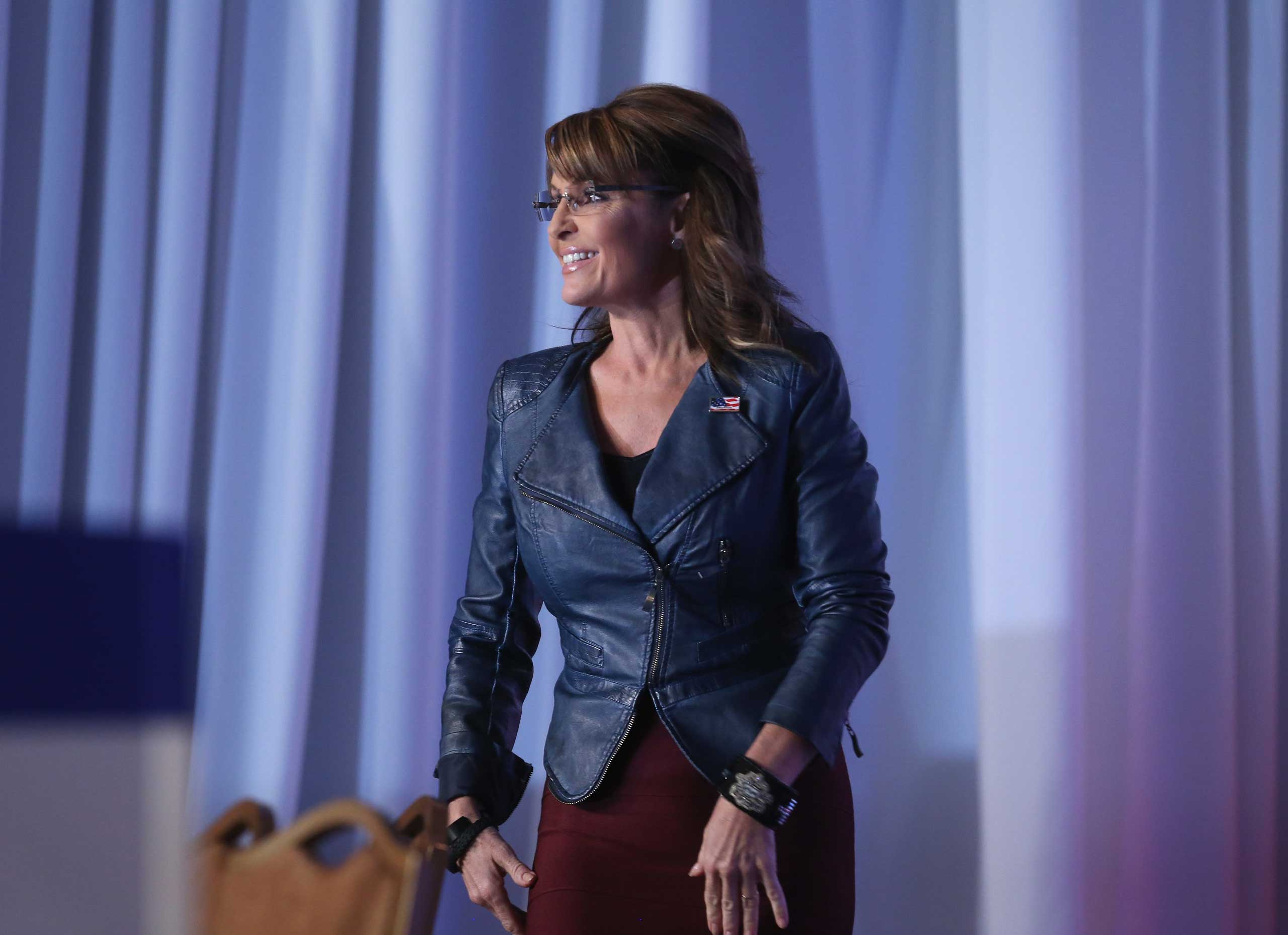 Former Alaska Gov. Sarah Palin (R) walks onstage to speak at the 2014 Values Voter Summit in Washington on Sept. 26, 2014. (Mark Wilson—Getty Images)