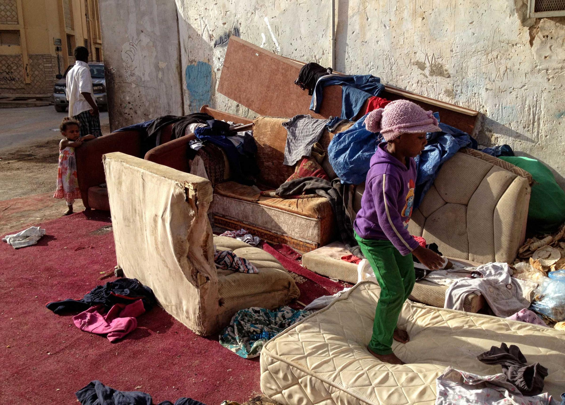 Saudi children play on old furniture outside of the home where they live in squalor in a neighborhood in South Riyadh, Saudi Arabia,  March 1, 2013.   Like many families across Saudi Arabia who are barely scraping above the poverty line each month, this family relies on the hope of the charity of others to survive. (Credit: Lynsey Addario/ VII)