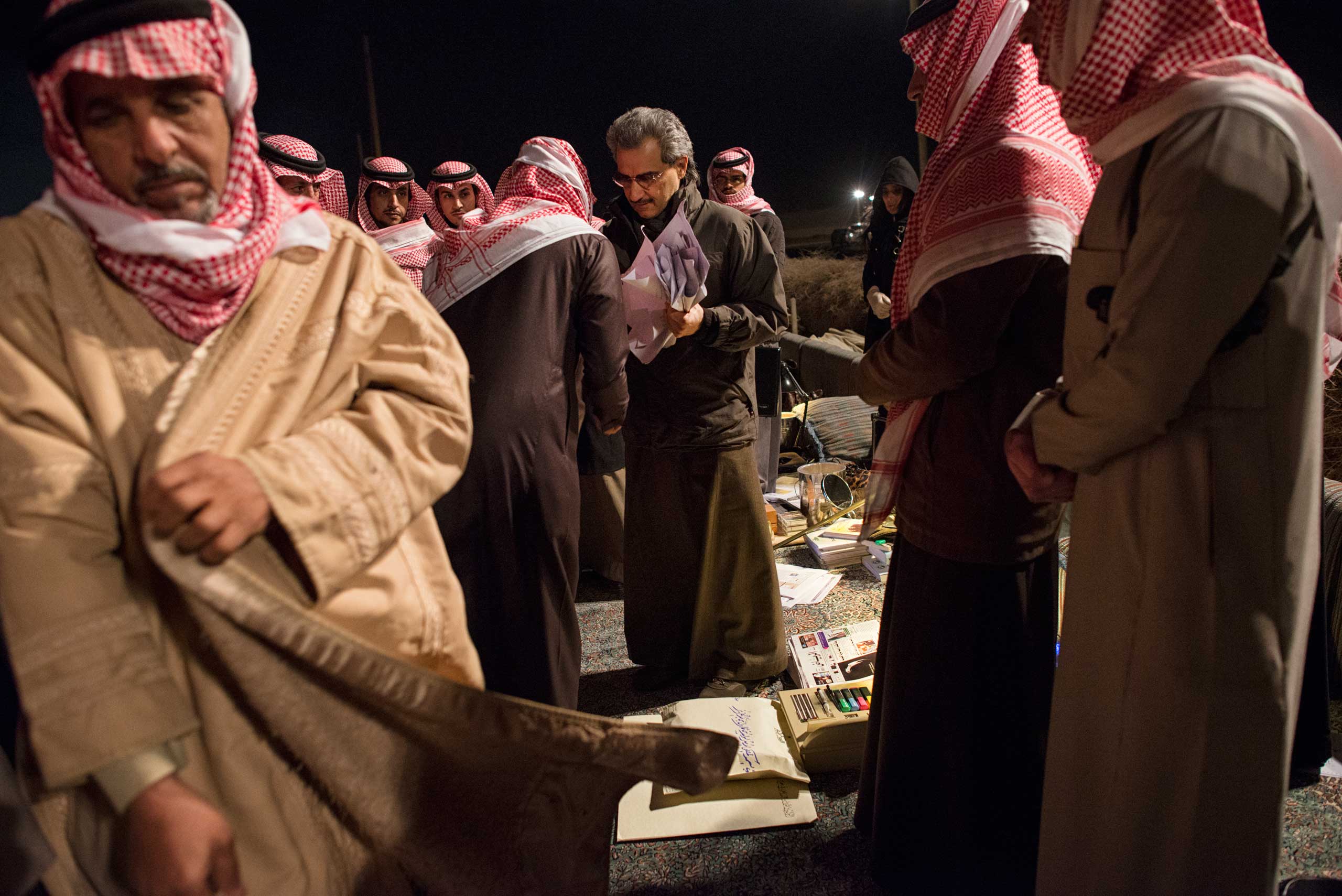 Saudi billionaire, HRH Prince Waleed bin Talal, greets Saudi citizens at a desert camp outside of Riyadh to accept their petitions for his help.