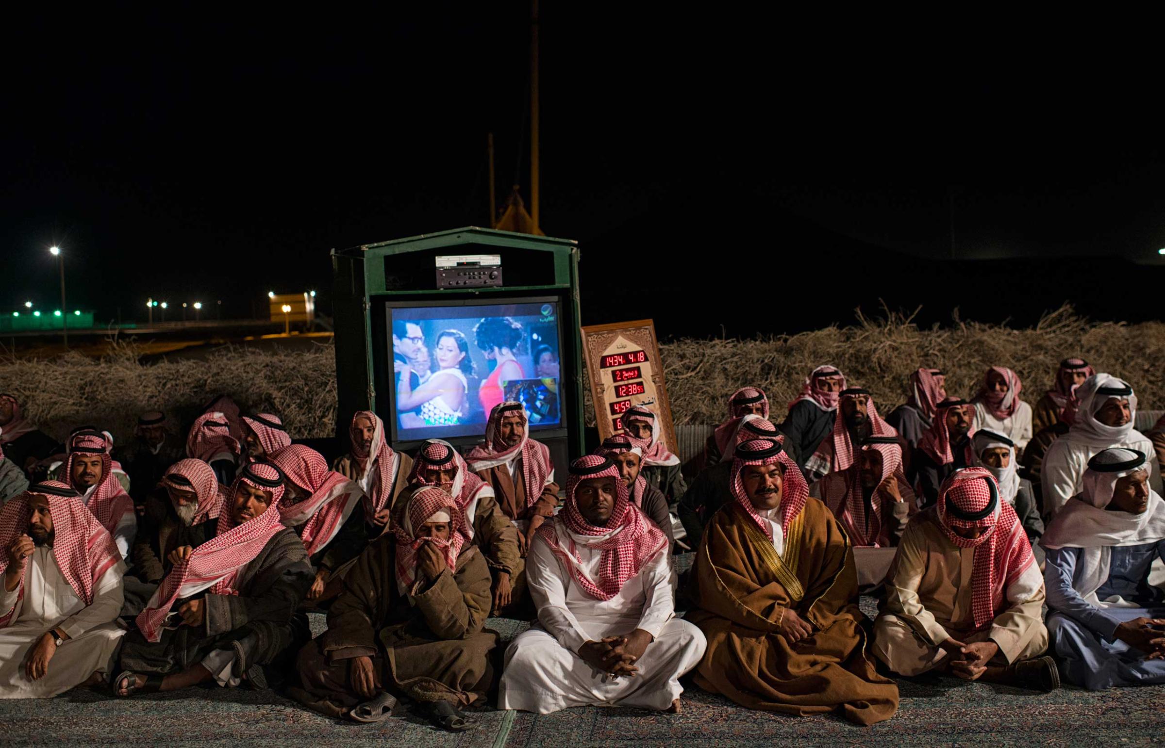 Saudi citizens rest after presenting Saudi Billionaire HRH Prince al Waleed bin Talal with petitions for his help at a desert camp outside of Riyadh, in Saudi Arabia, February 27, 2013.   Like many families across Saudi Arabia who are barely scraping above the poverty line each month, many poor Saudis rely on the hope of the charity of others to survive. (Credit: Lynsey Addario/ VII)