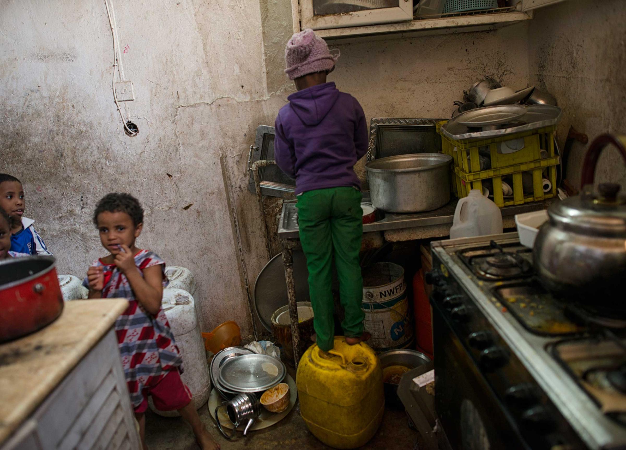 Saudi children do dishes and live in squalor in a neighborhood in South Riyadh, Saudi Arabia,  March 1, 2013.   Like many families across Saudi Arabia who are barely scraping above the poverty line each month, this family relies on the hope of the charity of others to survive. (Credit: Lynsey Addario/ VII)