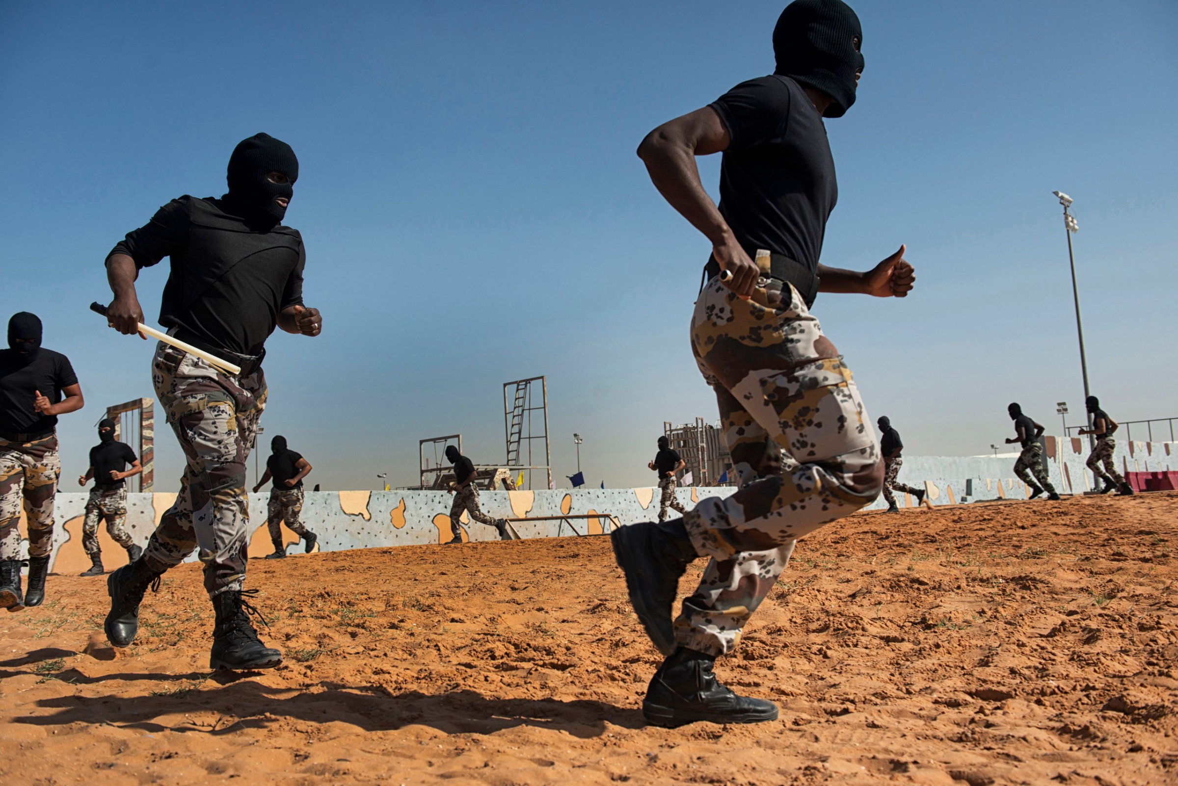 Troops with the Saudi Special Security Forces warm up and perform basic exercizes to increase strength and agility at the Counter-Terrorism Training School camp under the Ministry of Interior in Riyadh, Saudi Arabia, March 5, 2013.  The Saudi government has been fighting terrorism within the Kingdom for decades, and has roughly 3,000 SEF in Riyadh, alone.  Despite a fraugh relationship with the United States in the past, Saudi Arabia and the U.S. have routinely shared security information in order to prevent and fight terrorism.  With the recent death of HRH King Abdullah, the international community is looking to the newly appointed HRH King Salman to see how he develop the Kingdom's relationship with the West.  (Credit: Lynsey Addario/ Getty Reportage)