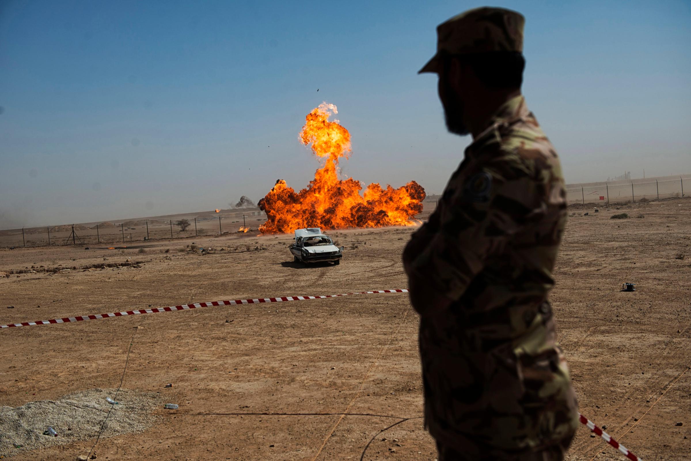 A troop with the Saudi Special Security Forces watches a remote detonation at the Counter-Terrorism Training School camp under the Ministry of Interior in Riyadh, Saudi Arabia, March 5, 2013.  The Saudi government has been fighting terrorism within the Kingdom for decades, and has roughly 3,000 SEF in Riyadh, alone.  Despite a fraugh relationship with the United States in the past, Saudi Arabia and the U.S. have routinely shared security information in order to prevent and fight terrorism.   (Credit: Lynsey Addario/ Getty Reportage)