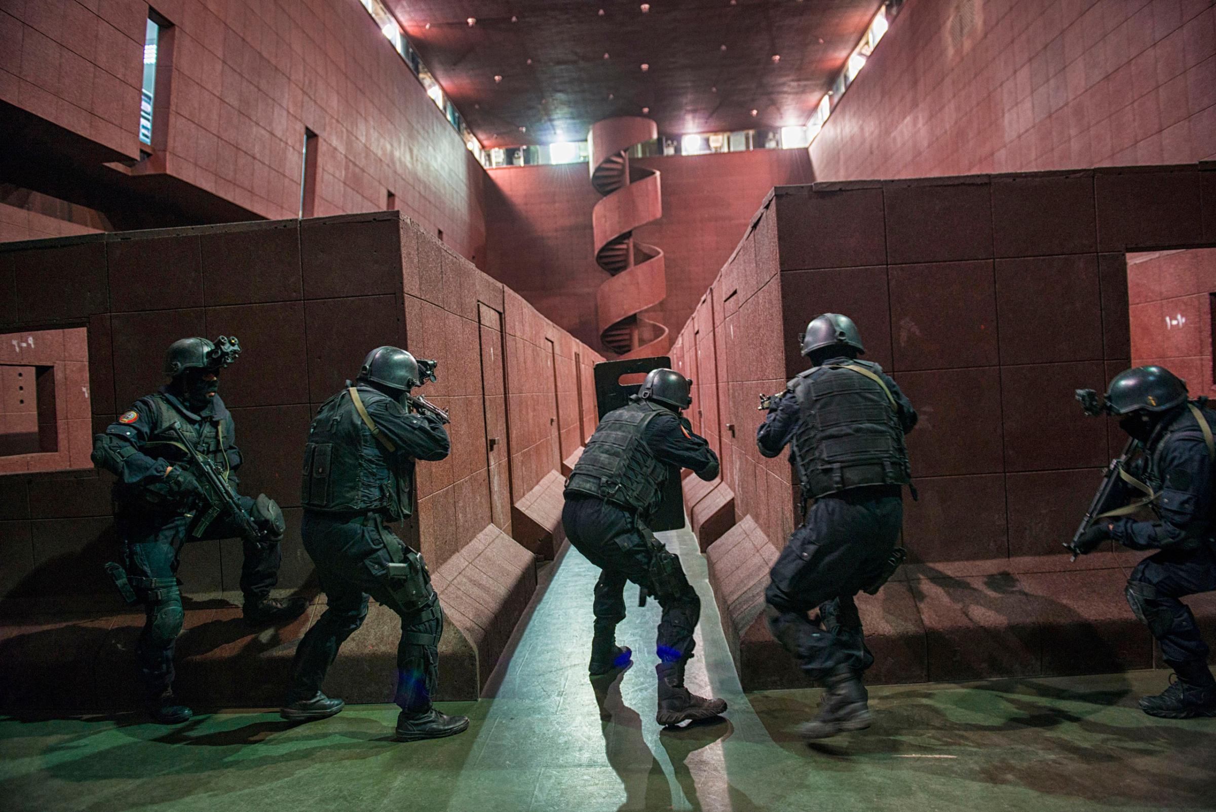Saudi Special Security Forces perform a simulated raid on a terrorist compound at an indoor shooting range at the Counter-Terrorism Training School camp under the Ministry of Interior in Riyadh, Saudi Arabia, March 5, 2013.  The Saudi government has been fighting terrorism within the Kingdom for decades, and has roughly 3,000 SEF in Riyadh, alone.  Despite a fraugh relationship with the United States in the past, Saudi Arabia and the U.S. have routinely shared security information in order to prevent and fight terrorism.  With the recent death of HRH King Abdullah, the international community is looking to the newly appointed HRH King Salman to see how he develop the Kingdom's relationship with the West.  (Credit: Lynsey Addario/ Getty Reportage)
