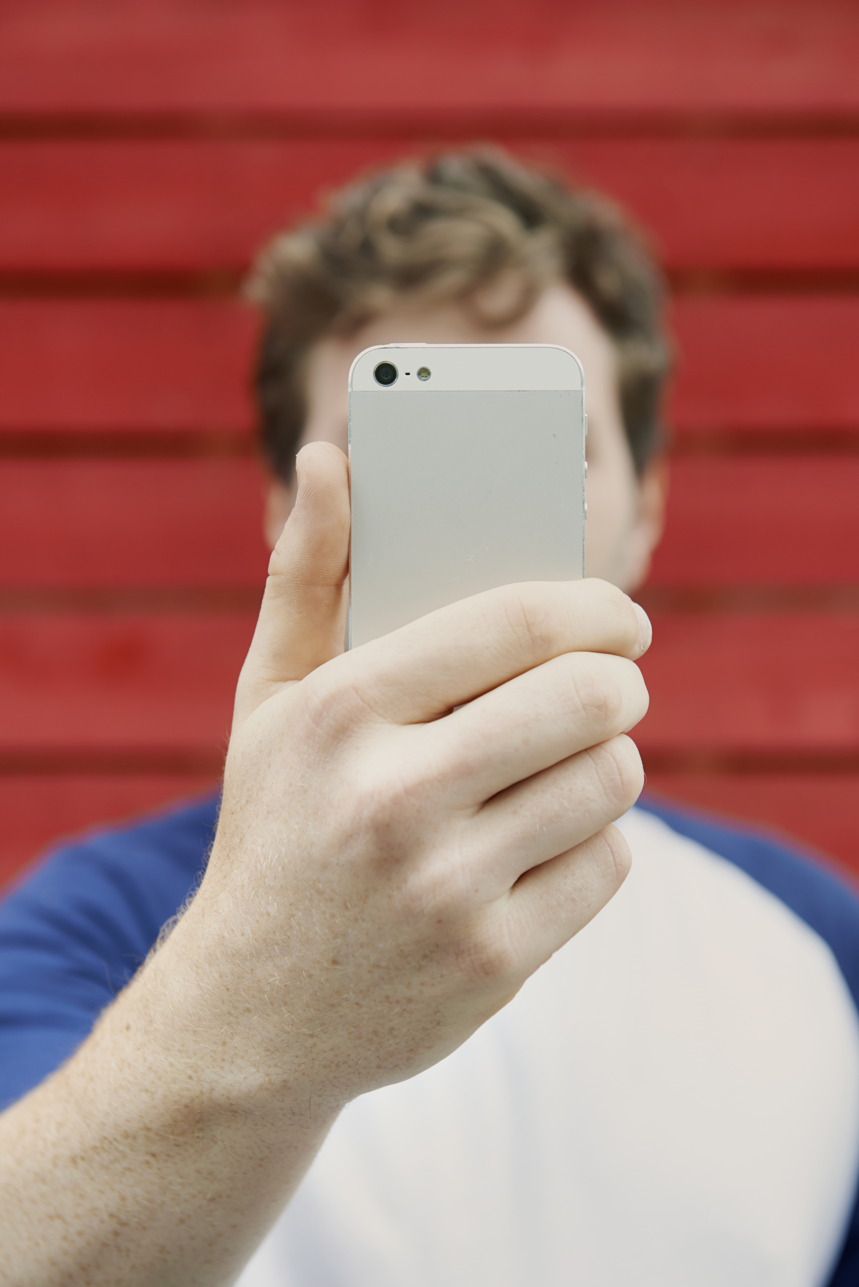 man holding up mobile to take selfie