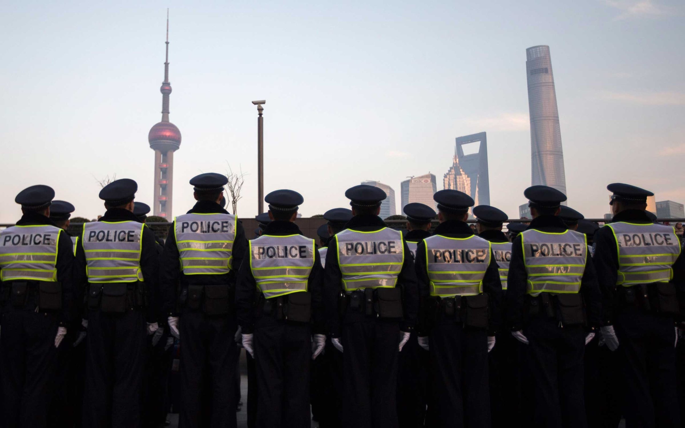 Policemen stand in formation as they guard on the bund where people were killed in a stampede incident during a new year's celebration, in Shanghai