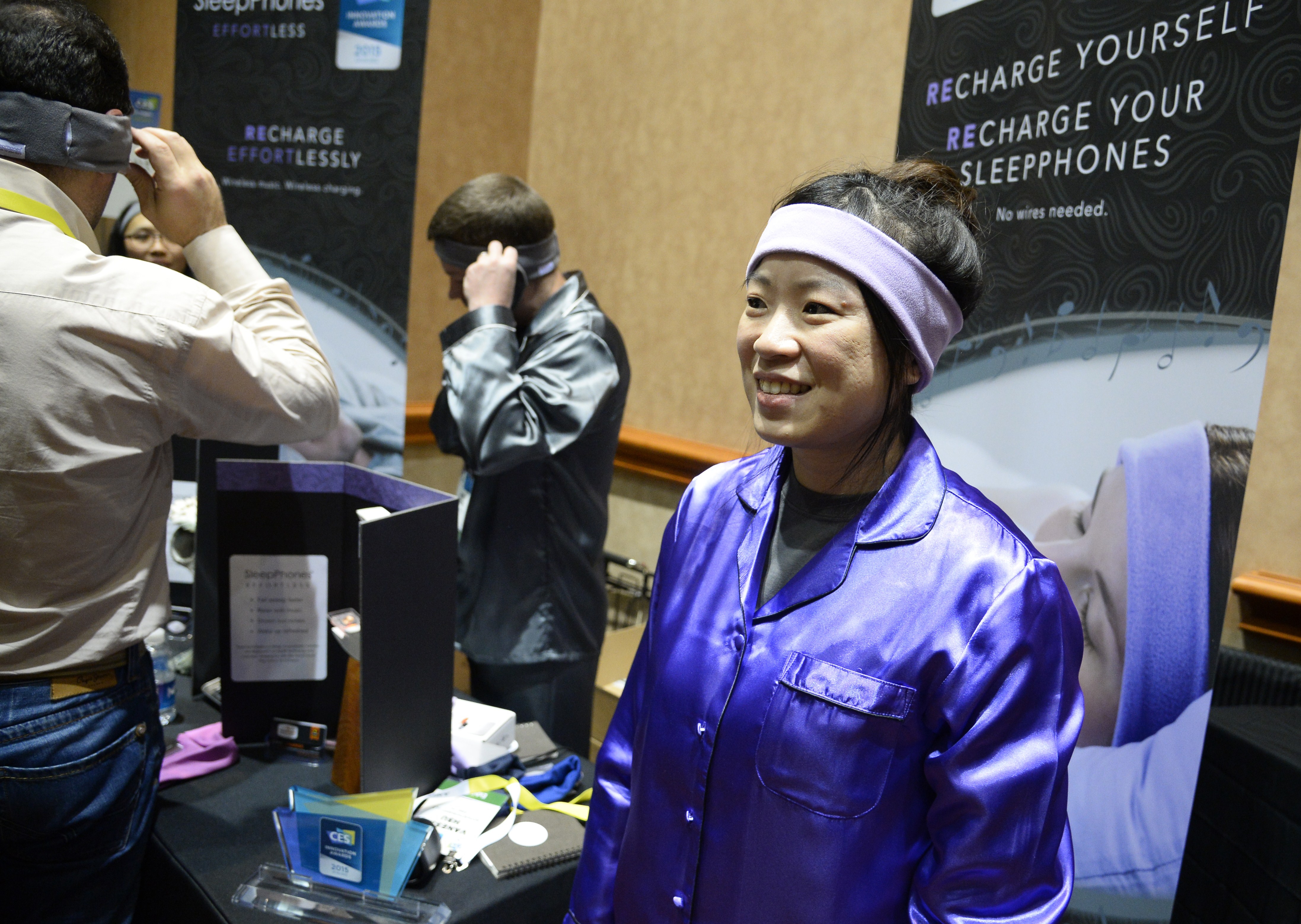 Dressed in pajamas, AcousticSheep LLC representative Venessa Hsu wears SleepPhones, a headband to help people to sleep better, during a press event at the Mandalay Bay Convention Center for the 2015 International CES on Jan. 4, 2015 in Las Vegas, Nevada. (Robyn Beck&mdash;AFP/Getty Images)