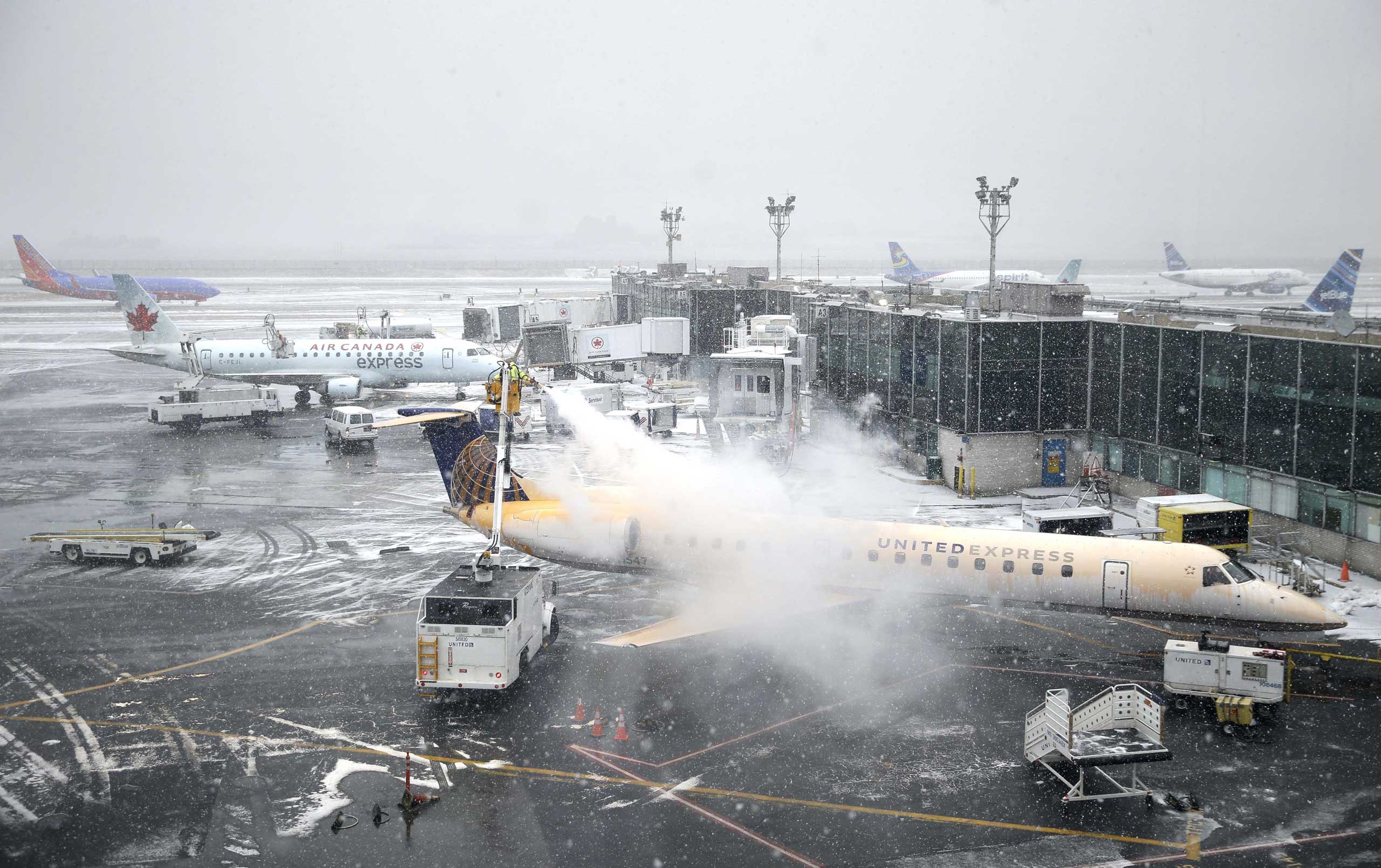 A plane is de-iced at LaGuardia Airport in New York City on Jan. 26, 2015. (Seth Wenig—AP)