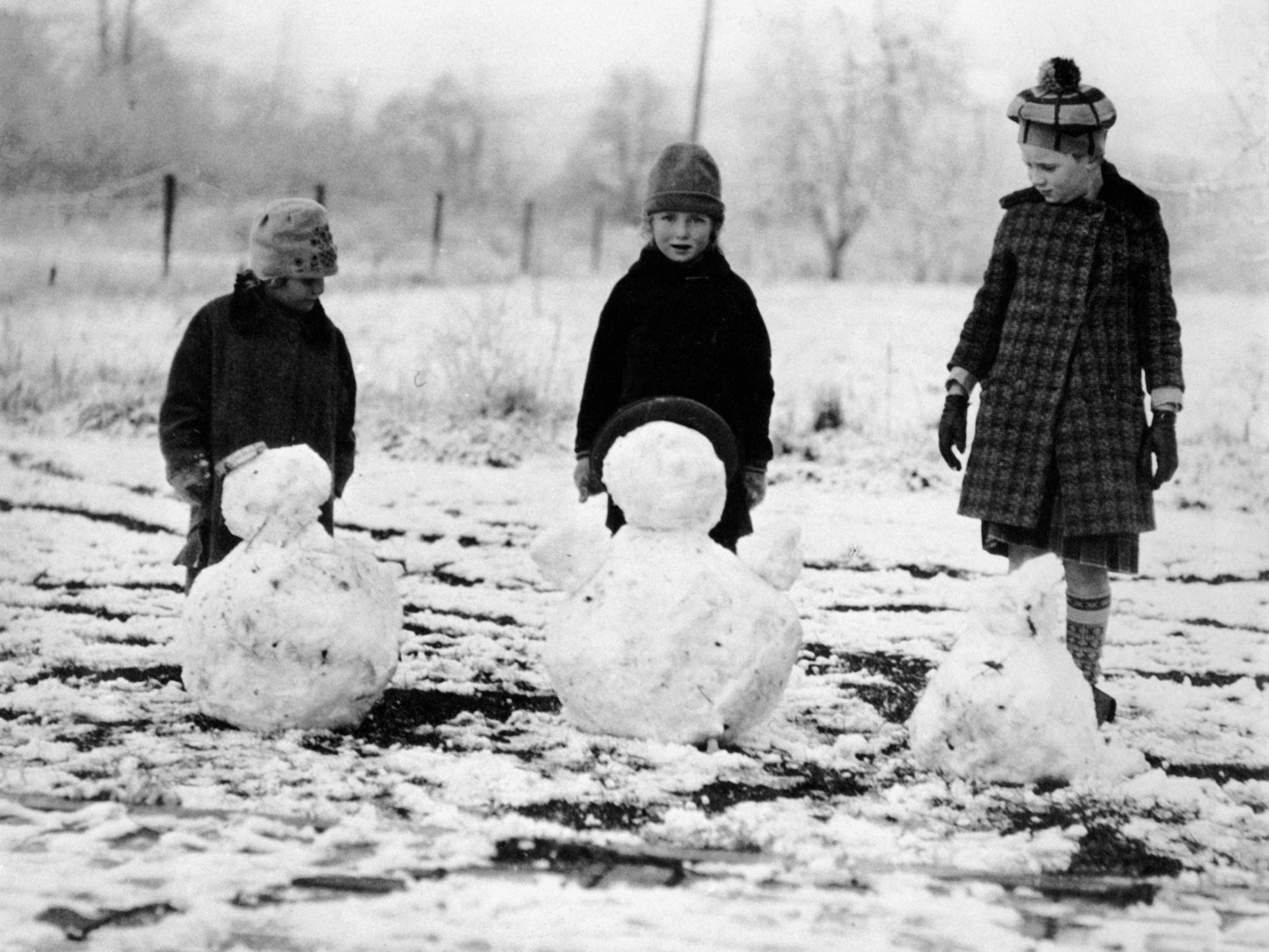 Girls And Boy Making Snowmen