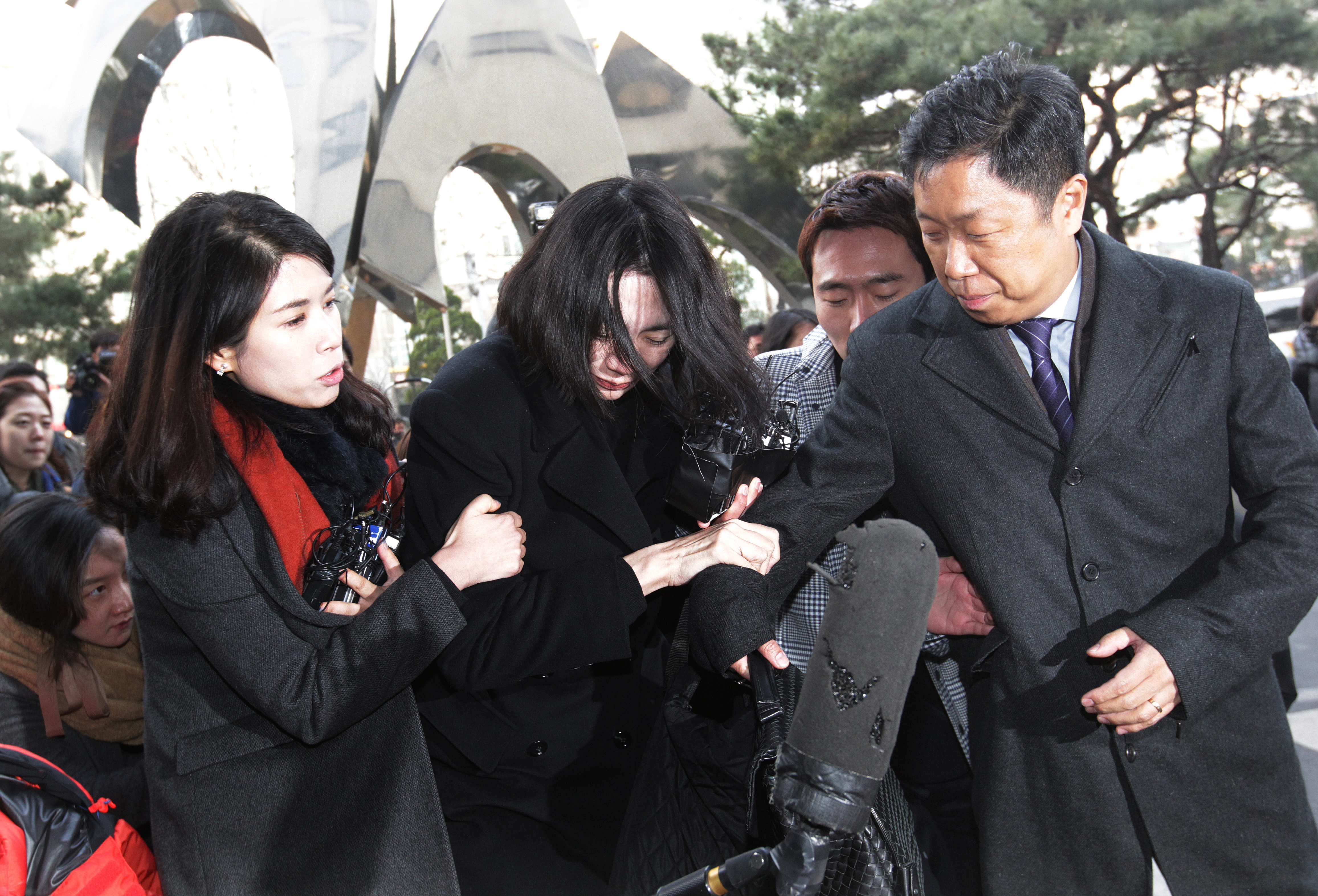 Cho Hyun-ah, center, former vice president of Korean Air Lines, arrives at the Seoul Western District Prosecutors' Office in Seoul on Dec. 30, 2014 (Ahn Young-joon—AP)
