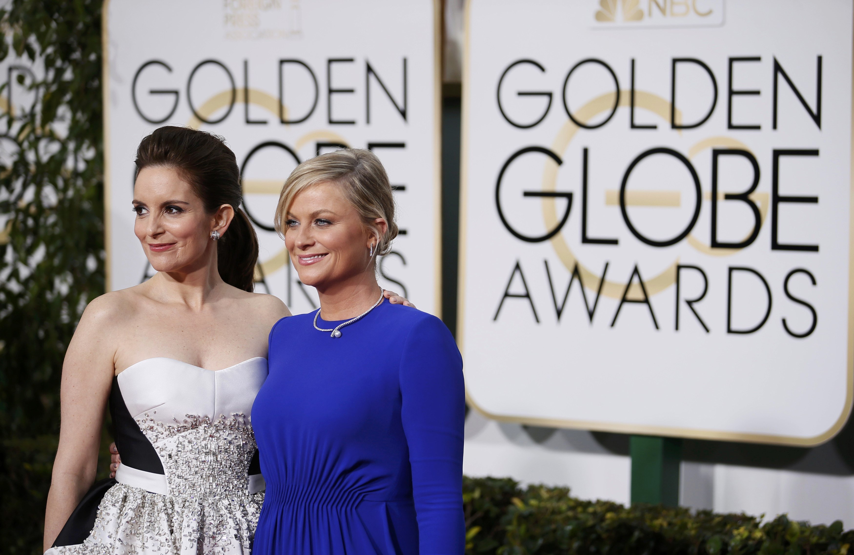 Show hosts Tina Fey and Amy Poehler arrive at the 72nd Golden Globe Awards in Beverly Hills