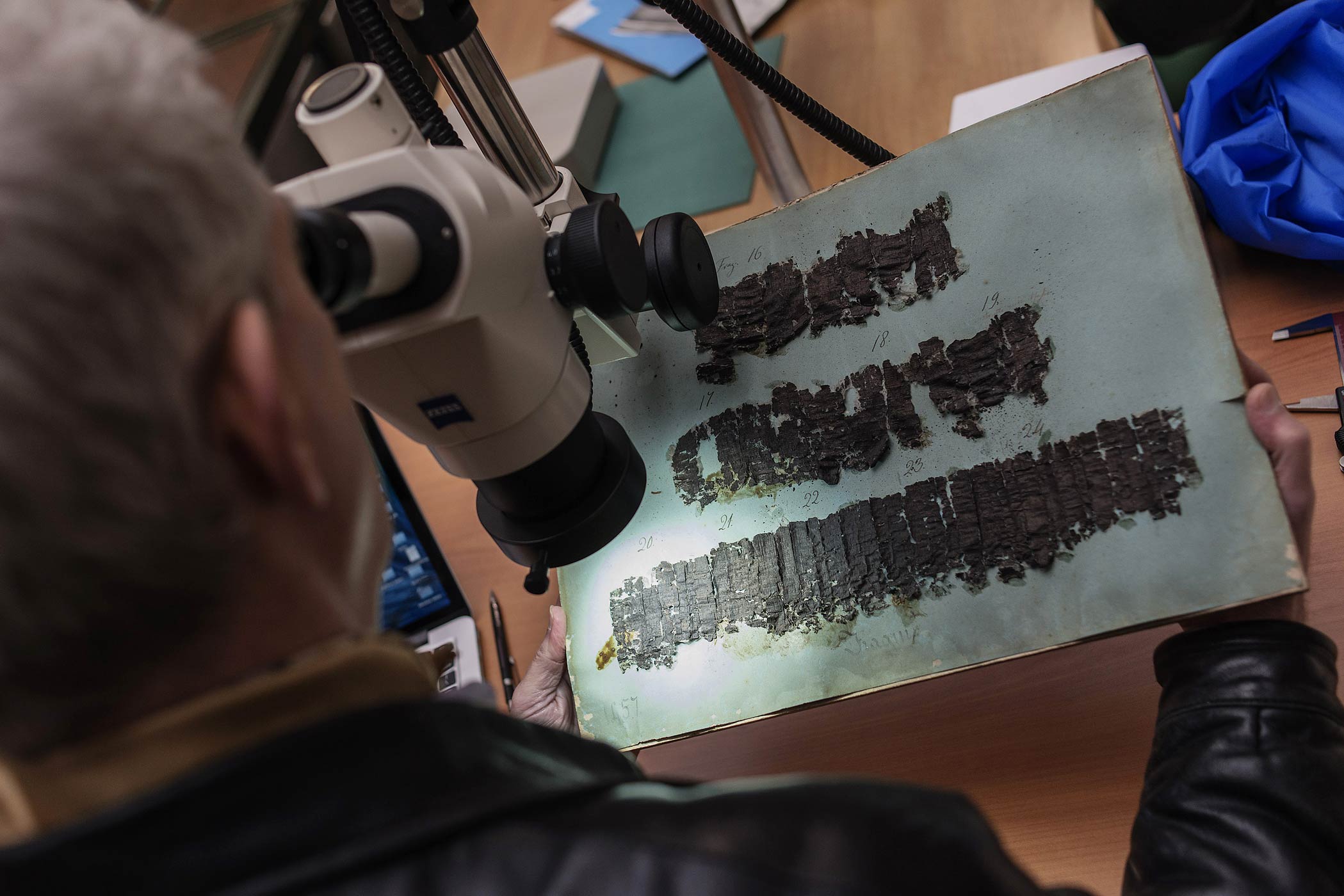 David Blank, professor of Classics from the University of California, looks through a microscope at an ancient papyrus at the Naples' National Library, Italy, Jan. 20, 2015. (Salvatore Laporta—AP)