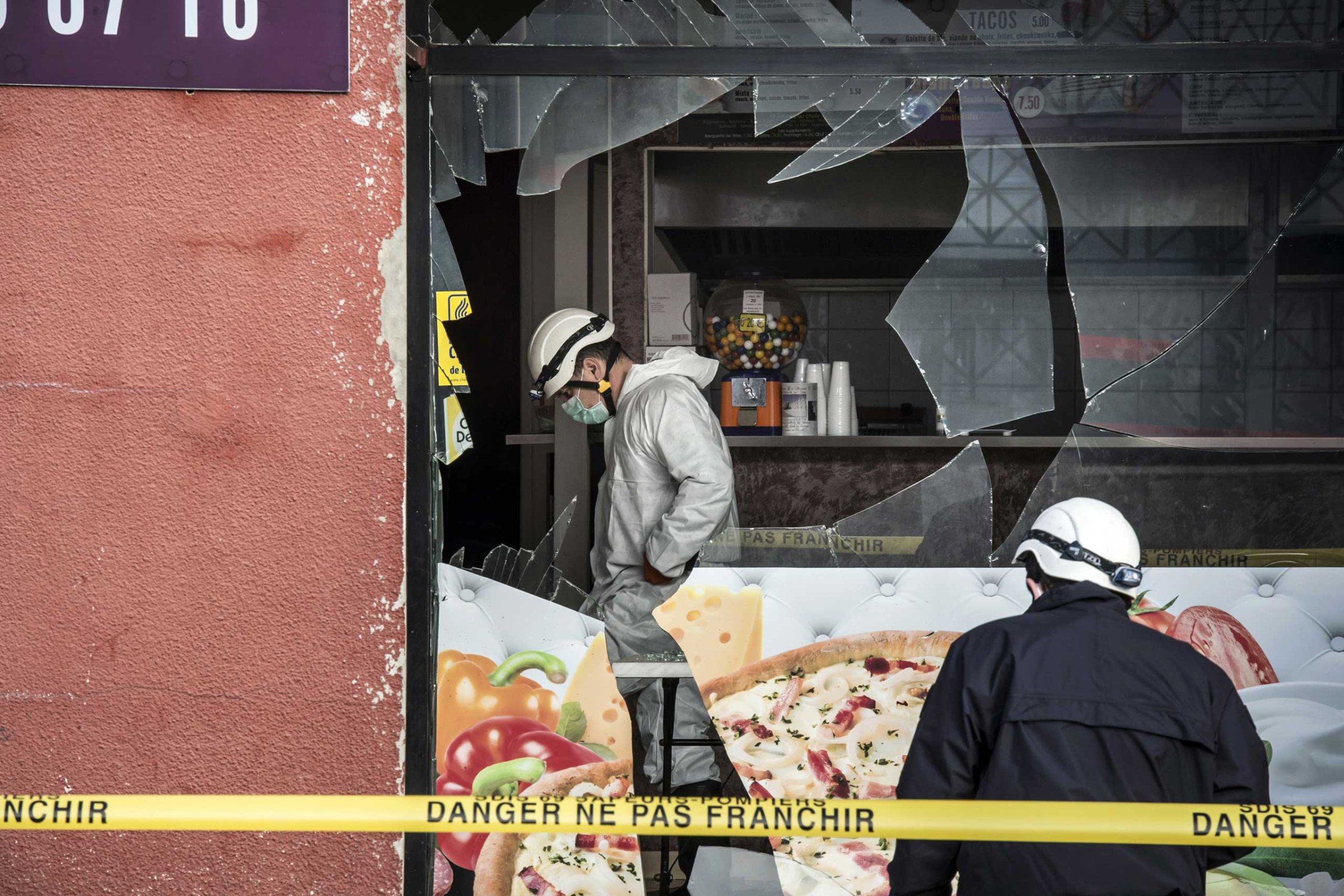 French police forensic scour the scene of an explosion at a kebab shop damaged following an explosion near a mosque, on Jan. 8, 2015, in Villefranche-sur-Saone, eastern France.