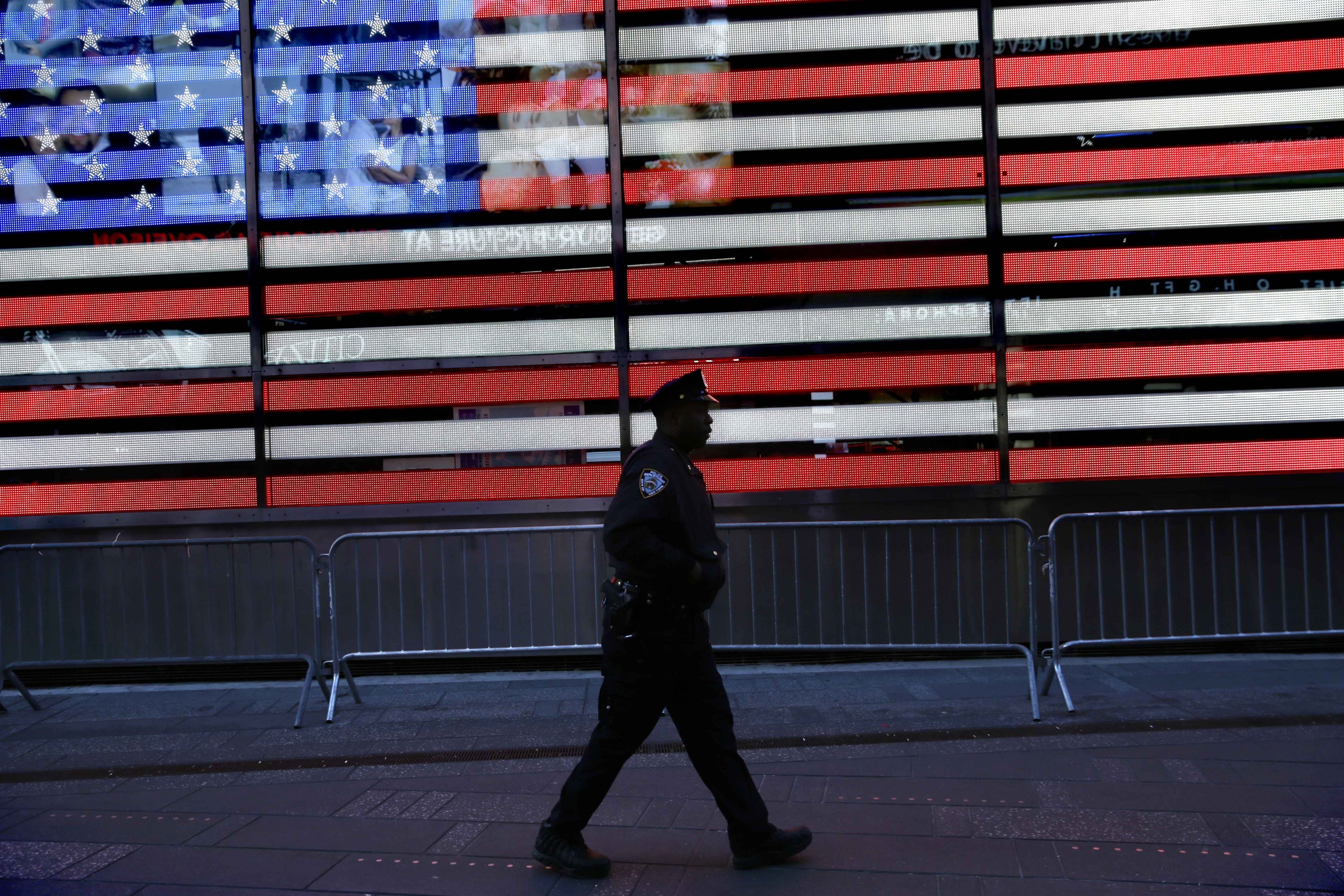 A police officer walks through Times Square in New York on Jan. 8, 2015. (Seth Wenig—AP)
