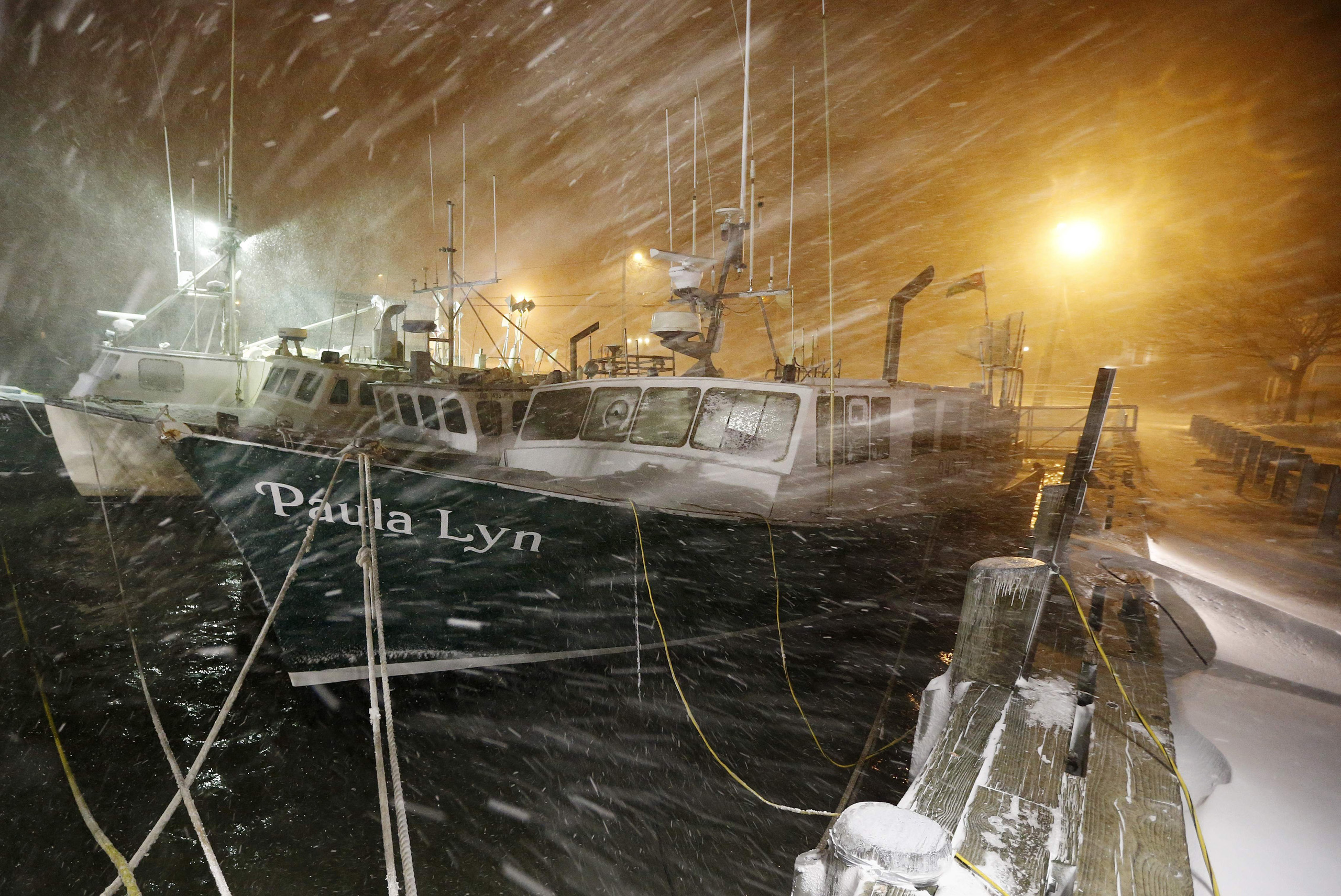 Fishing boats ride out the storm at dock in Scituate, Mass., on Jan. 27, 2015. (Michael Dwyer—AP)