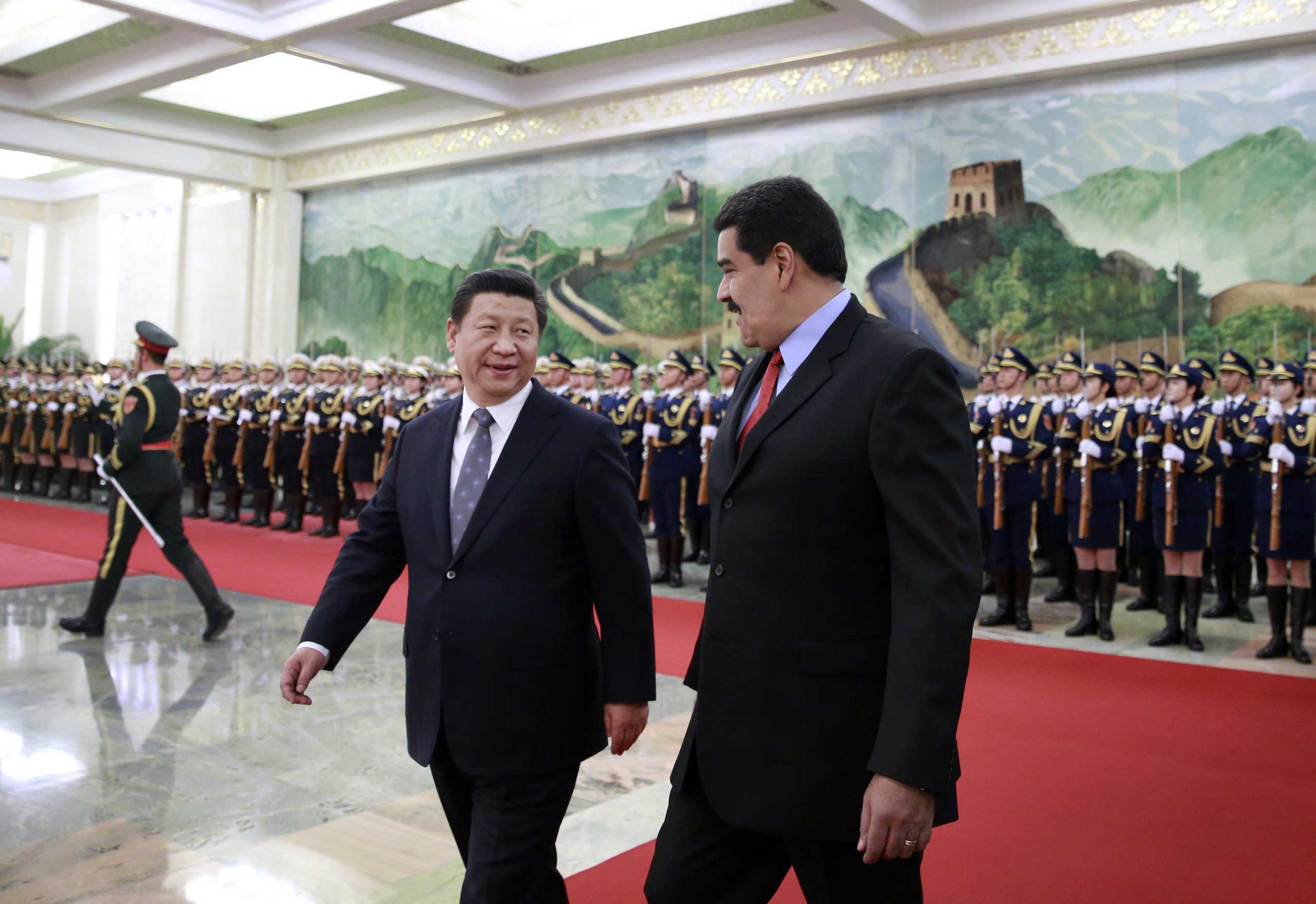 Venezuela's President Nicolas Maduro and Chinese President Xi Jinping chat after reviewing an honor guard during a welcome ceremony at the Great Hall of the People in Beijing on Jan. 7, 2015. (Andy Wong—AFP/Getty Images)