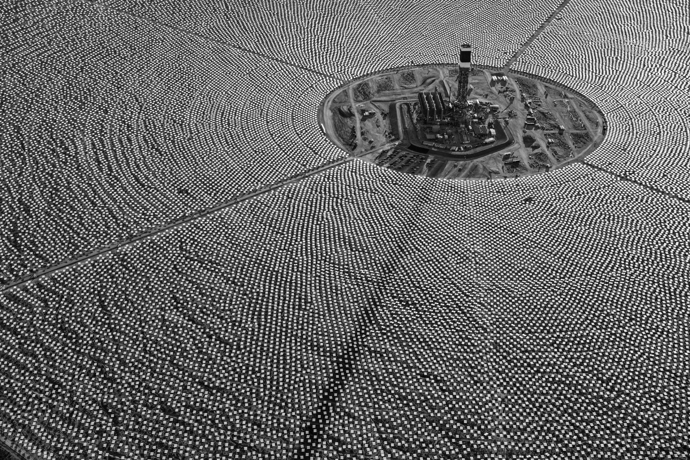 Mirrored Heliostats that reflect and concentrate desert sunshine surround a tower at the Ivanpah Solar power station in the Mojave Desert, California. Jamey Stillings