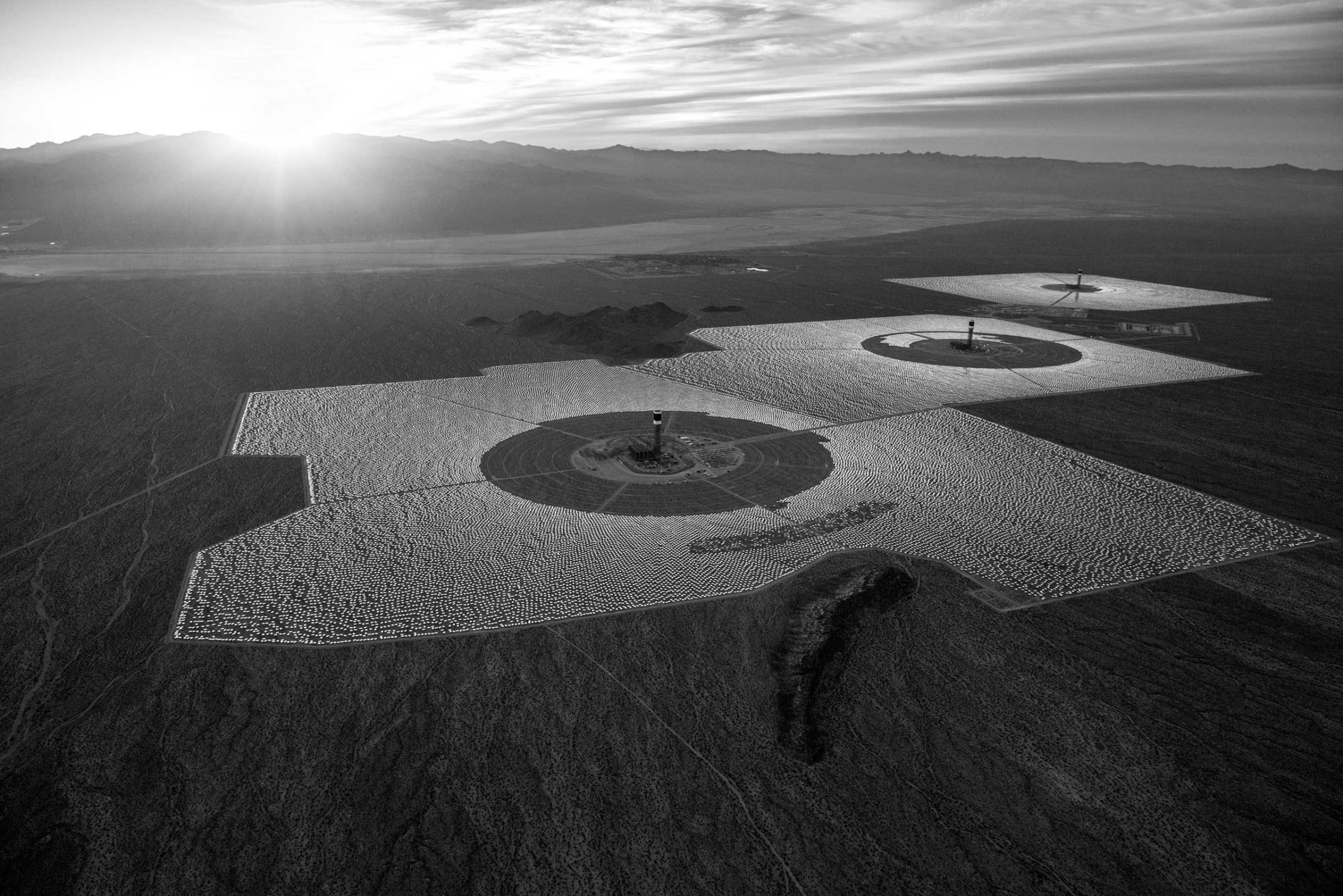 in the  Mojave Desert, California. Unlike solar photovoltaic plants, which generate electricity directly from sunlight, Ivanpah uses hundreds of thousands of curved mirrors to reflect and concentrate the desert sunshine. Jamey Stillings
