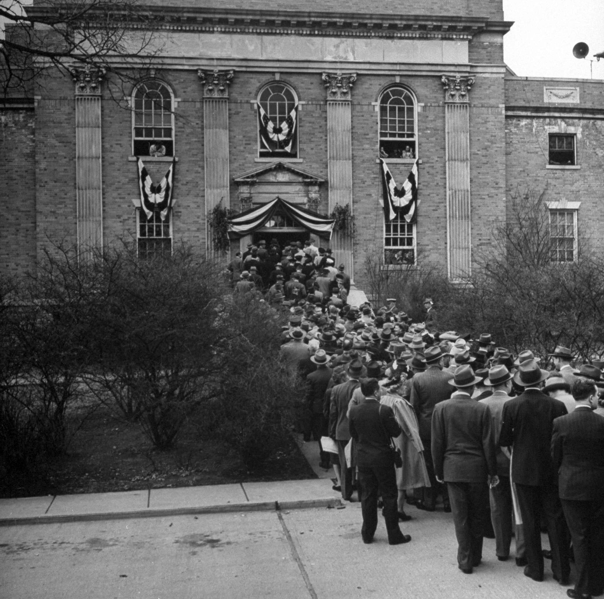 A long line of people waiting to enter the building where Sir Winston Churchill is making his speech, Missouri, 1946.